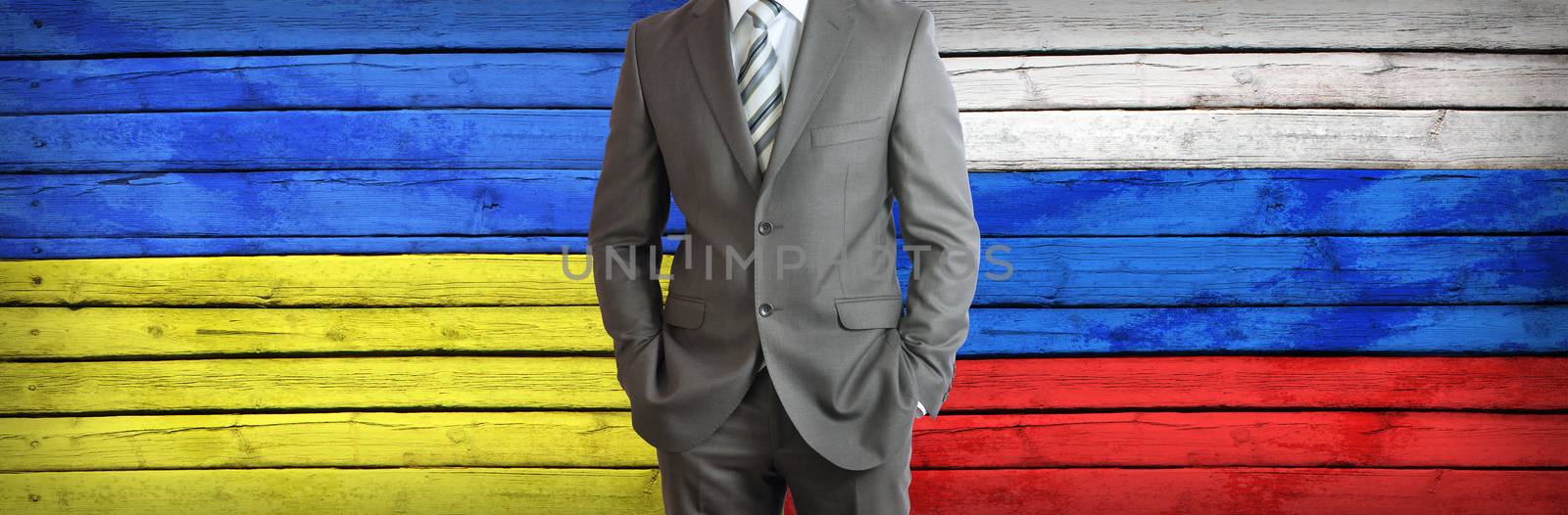 Businessman in a suit. Ukrainian and Russian flags as background. Concept of business