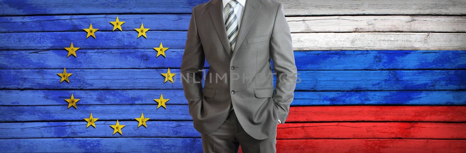 Businessman in a suit. European Union and Russian flags as background. Concept of business