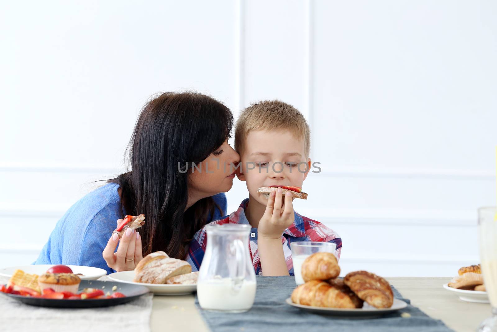 Mother with kid during family breakfast