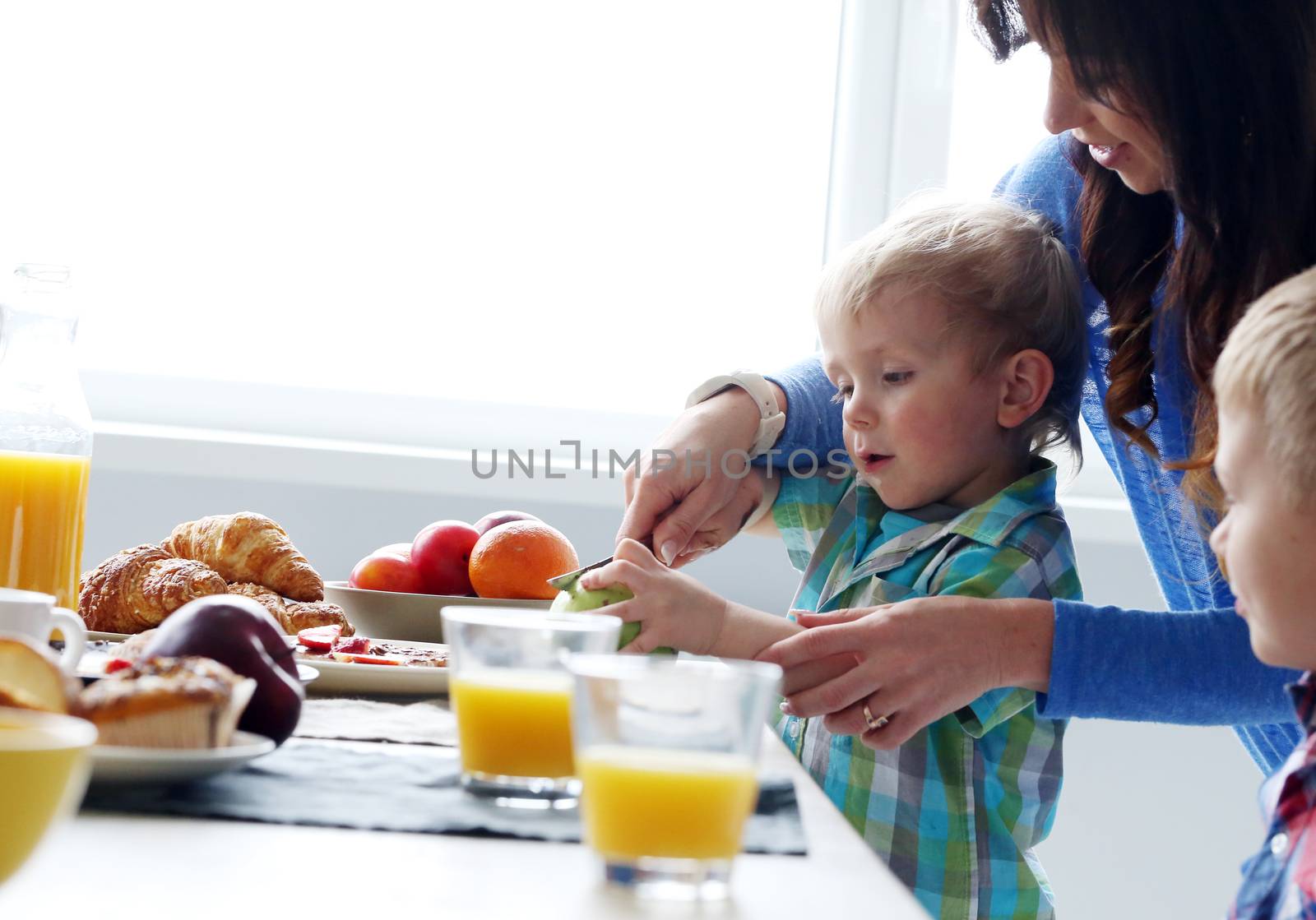 Mother and two brothers during family breakfast