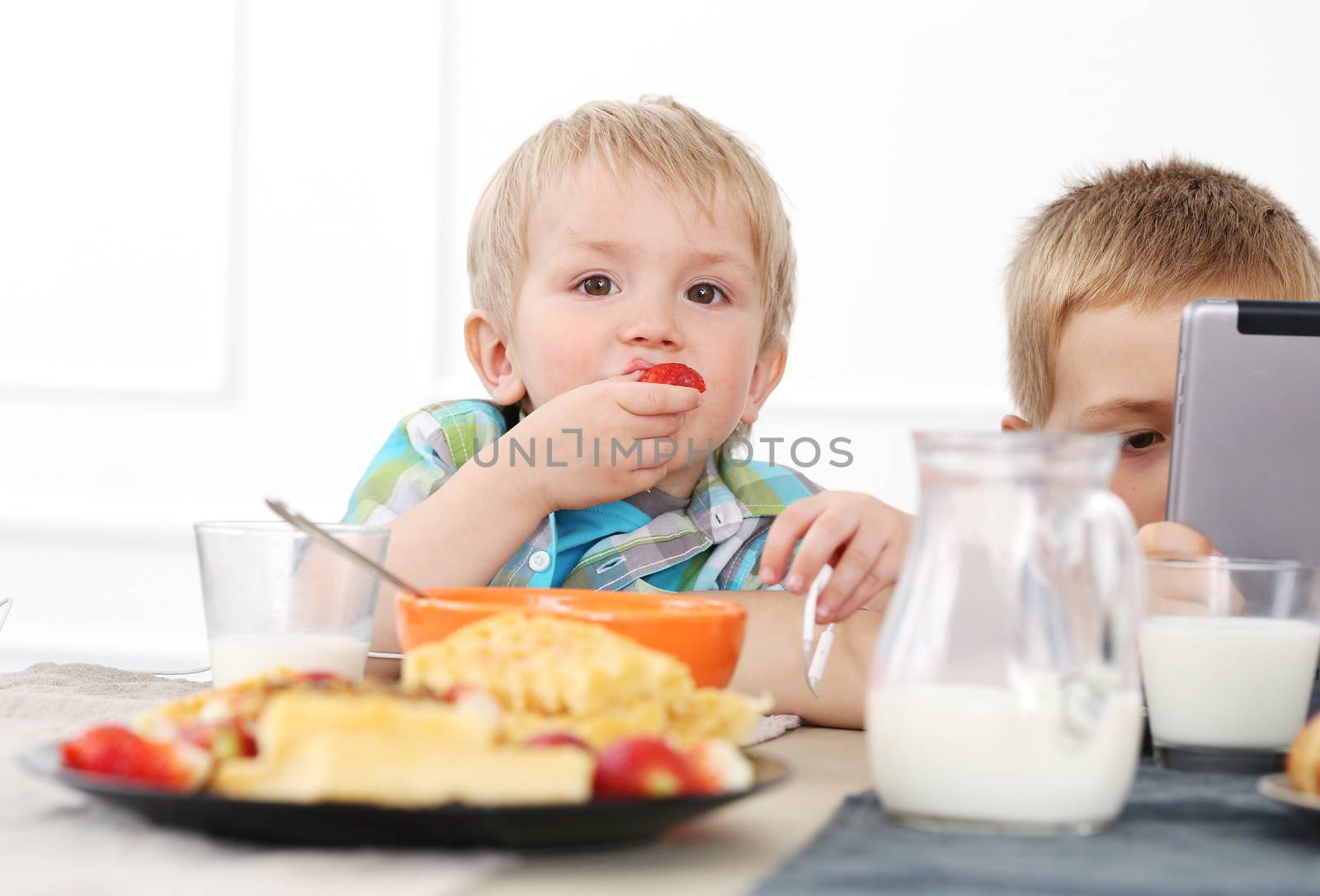 Two brothers during family breakfast