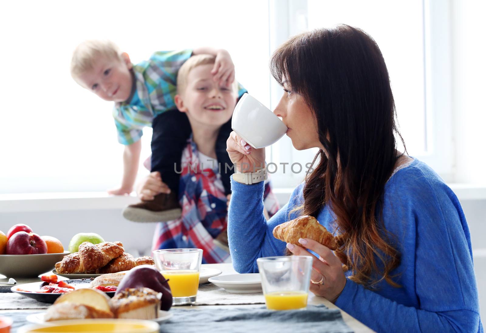 Mother and two brothers during family breakfast