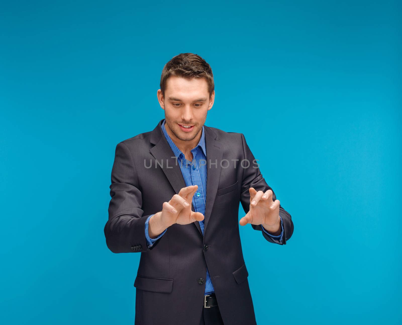 business, technology, communication concept - businessman working with imaginary virtual screen