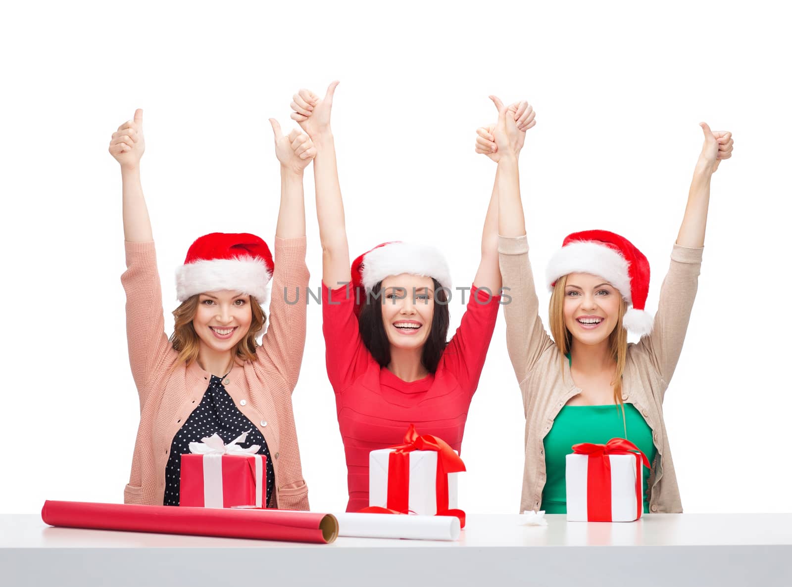 smiling women in santa helper hats with gift boxes by dolgachov