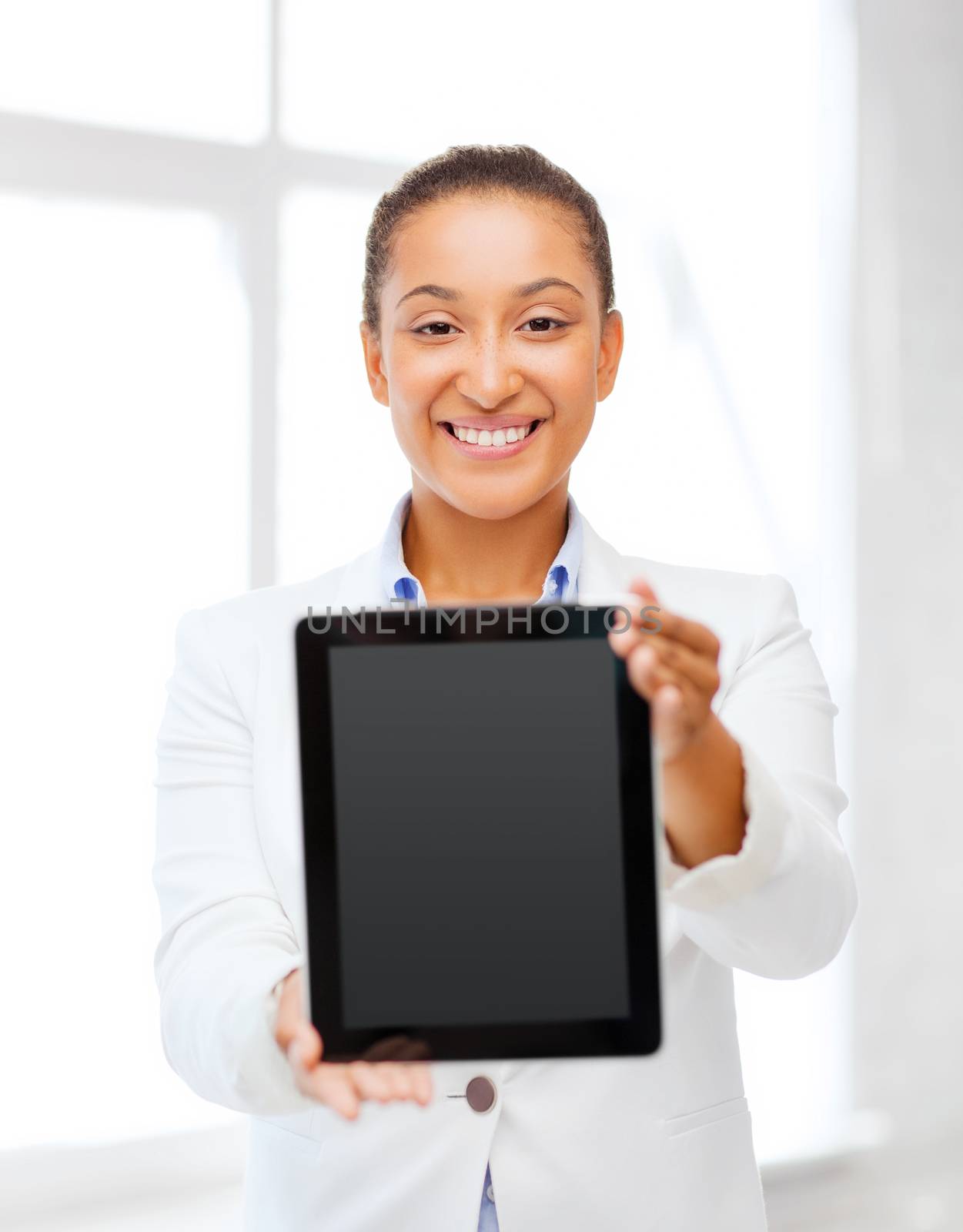 businesswoman with tablet pc in office by dolgachov
