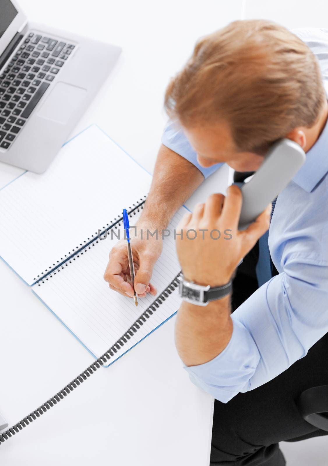 business, office, school and education concept - businessman talking on the phone