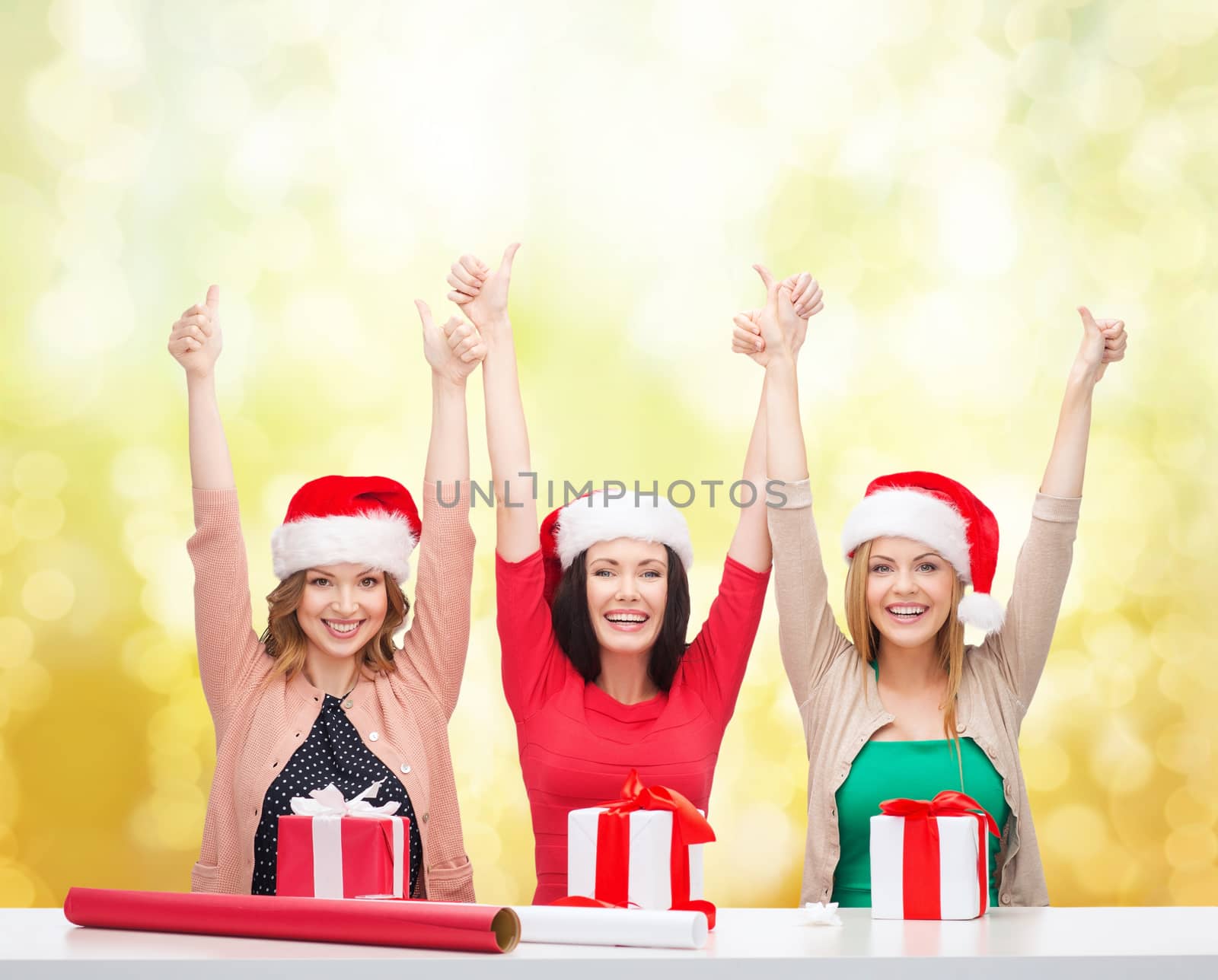 christmas, x-mas, winter, happiness concept - three smiling women in santa helper hats with gift boxes