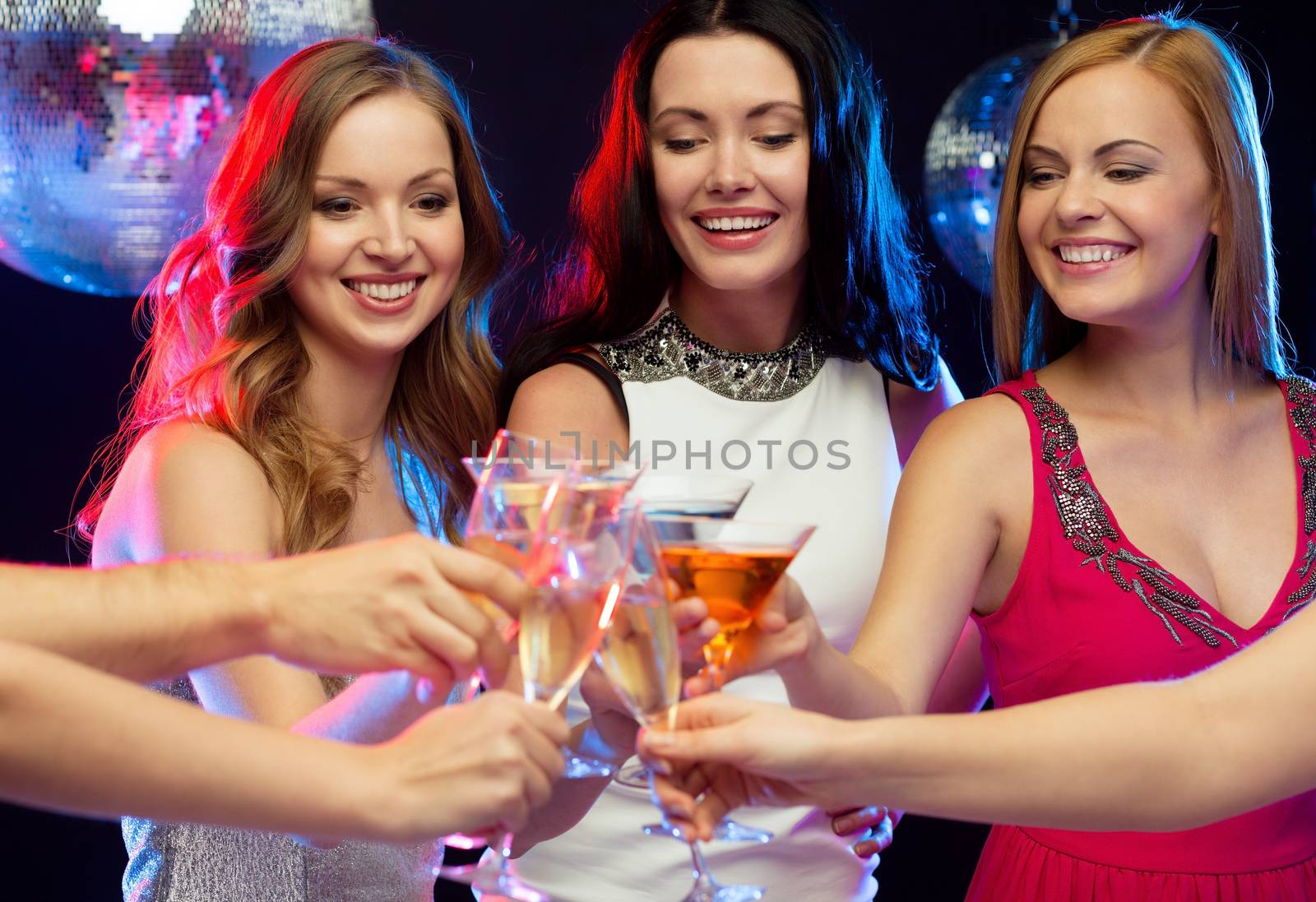 "new year", celebration, friends, bachelorette party, birthday concept - three women in evening dresses with cocktails in club or bar