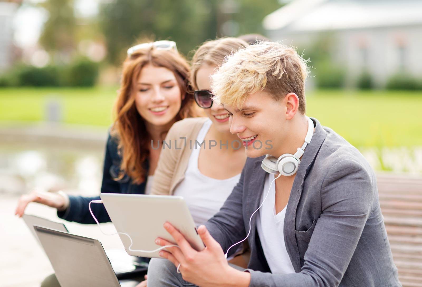 students or teenagers with laptop computers by dolgachov