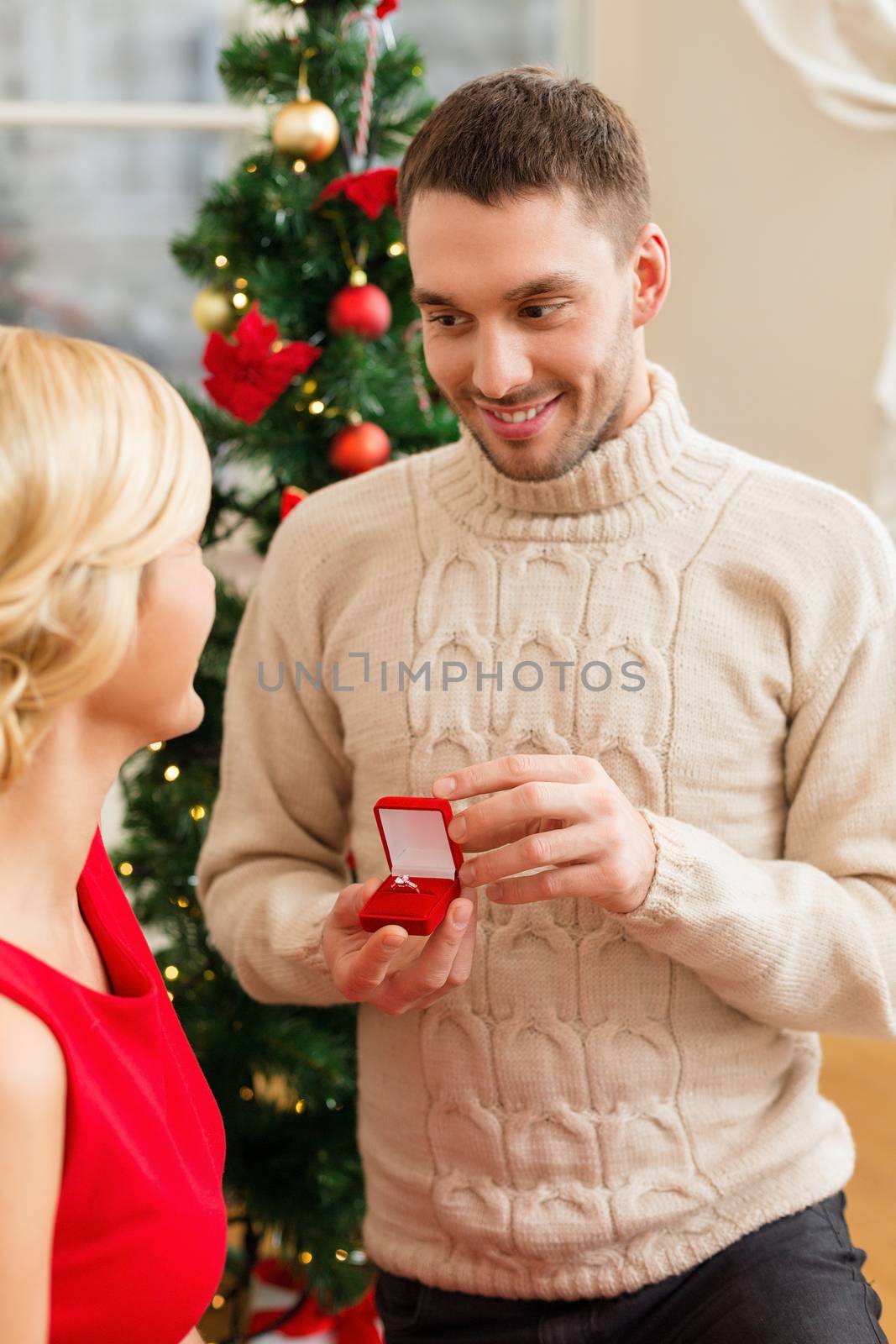 love, couple, christmas, x-mas, winter, relationship and dating concept - romantic man proposing to a woman in red dress