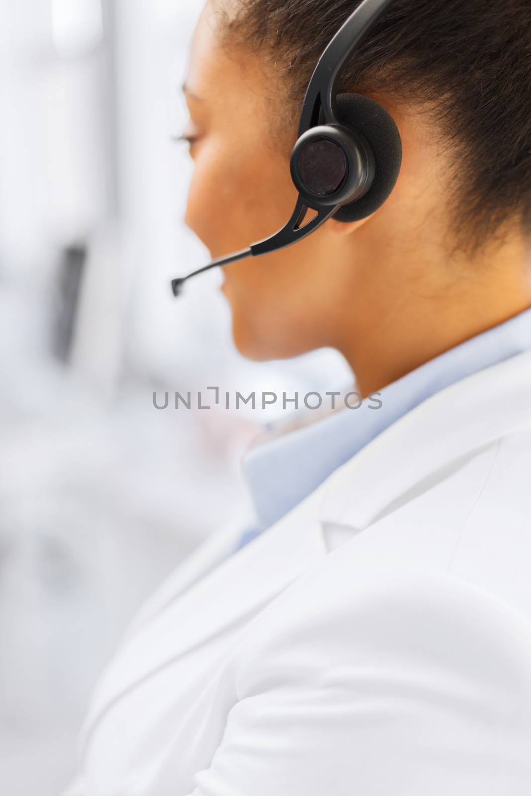 female helpline operator with headphones by dolgachov
