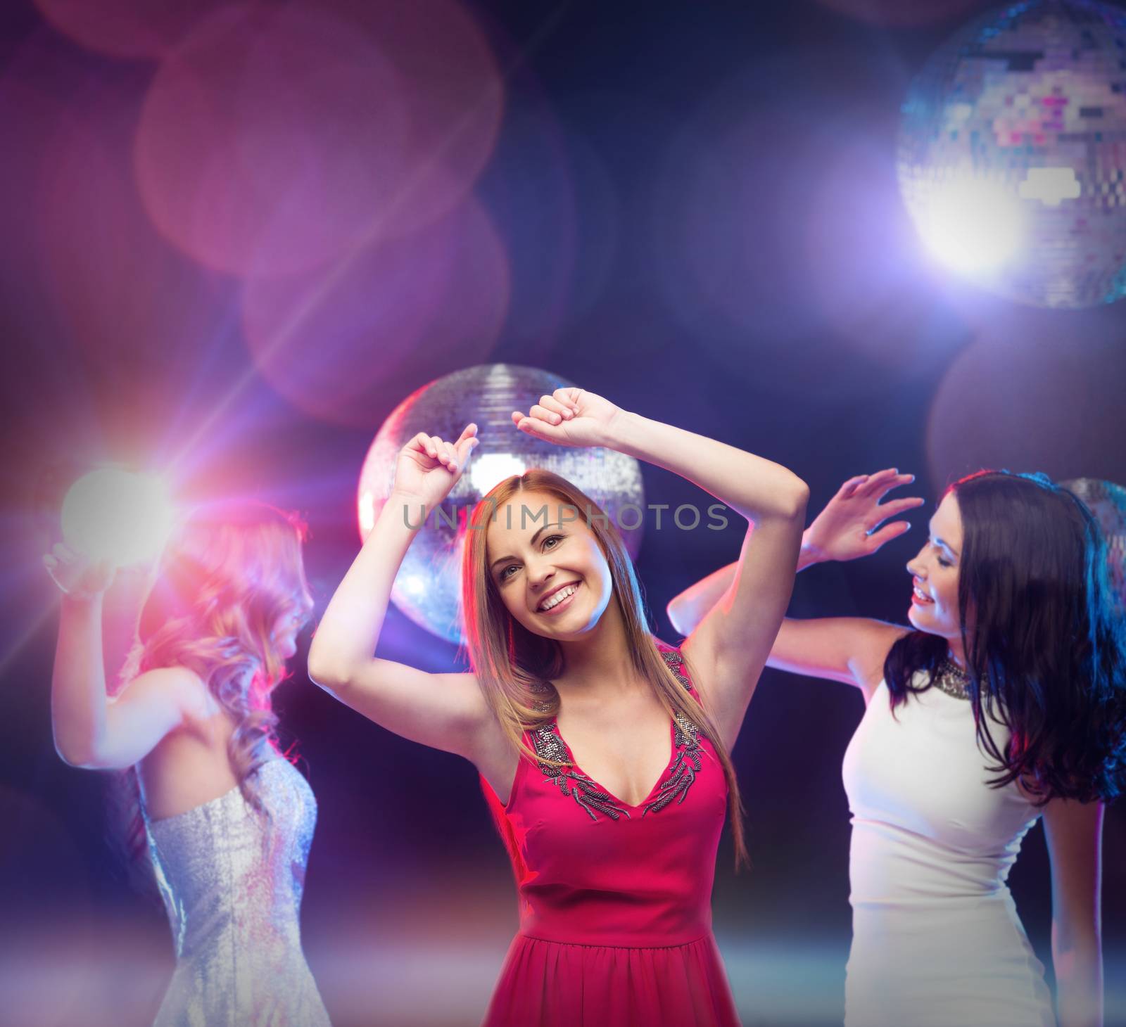three smiling women dancing in the club by dolgachov
