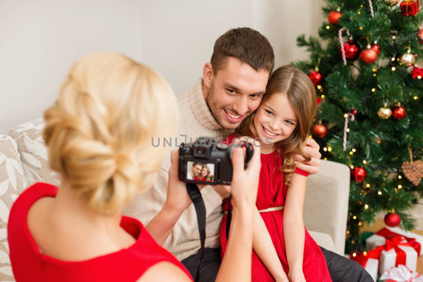 mother taking picture of father and daughter by dolgachov