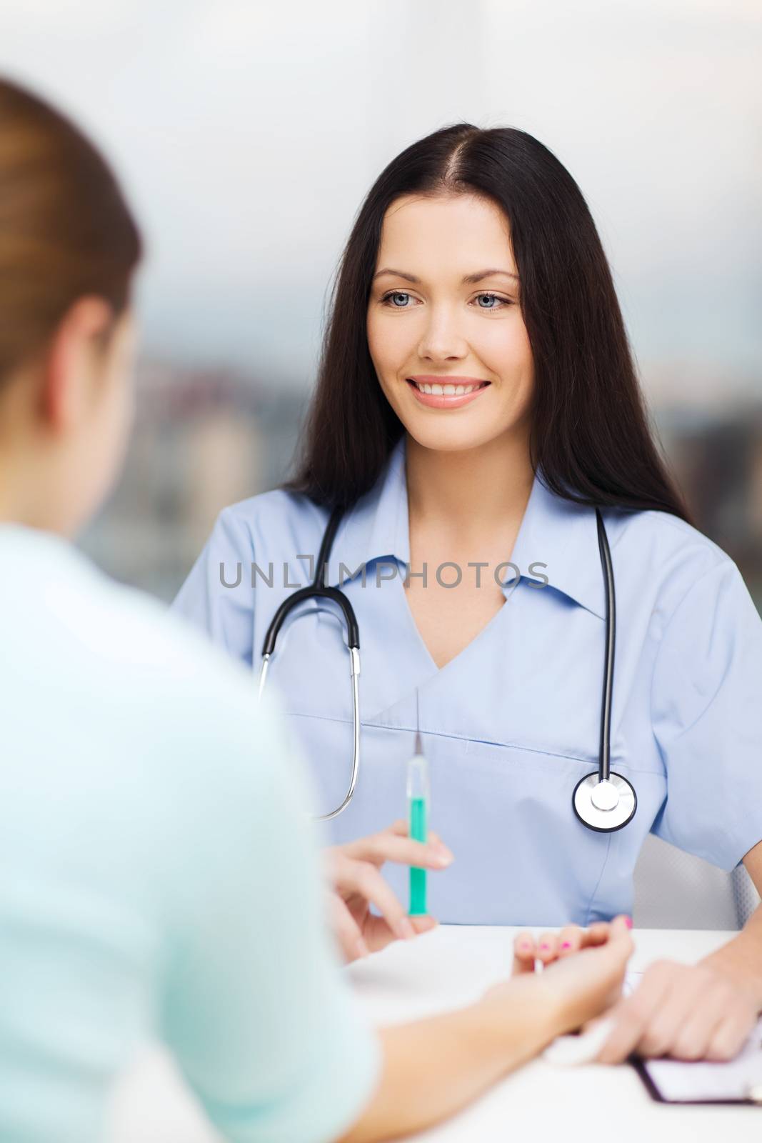 healthcare and medicine concept - smiling female doctor or nurse doing injection to patient