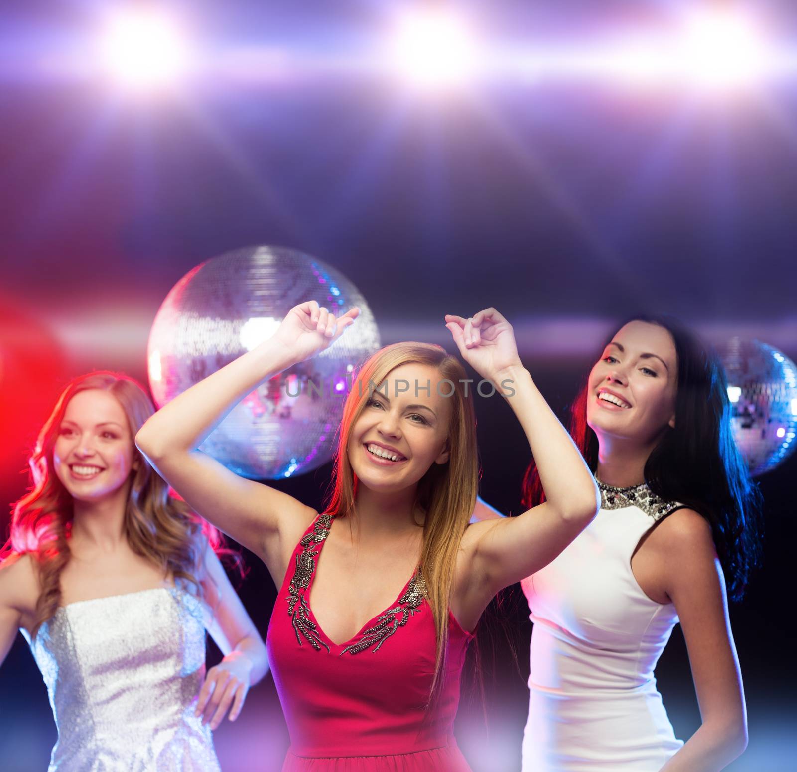 three smiling women dancing in the club by dolgachov