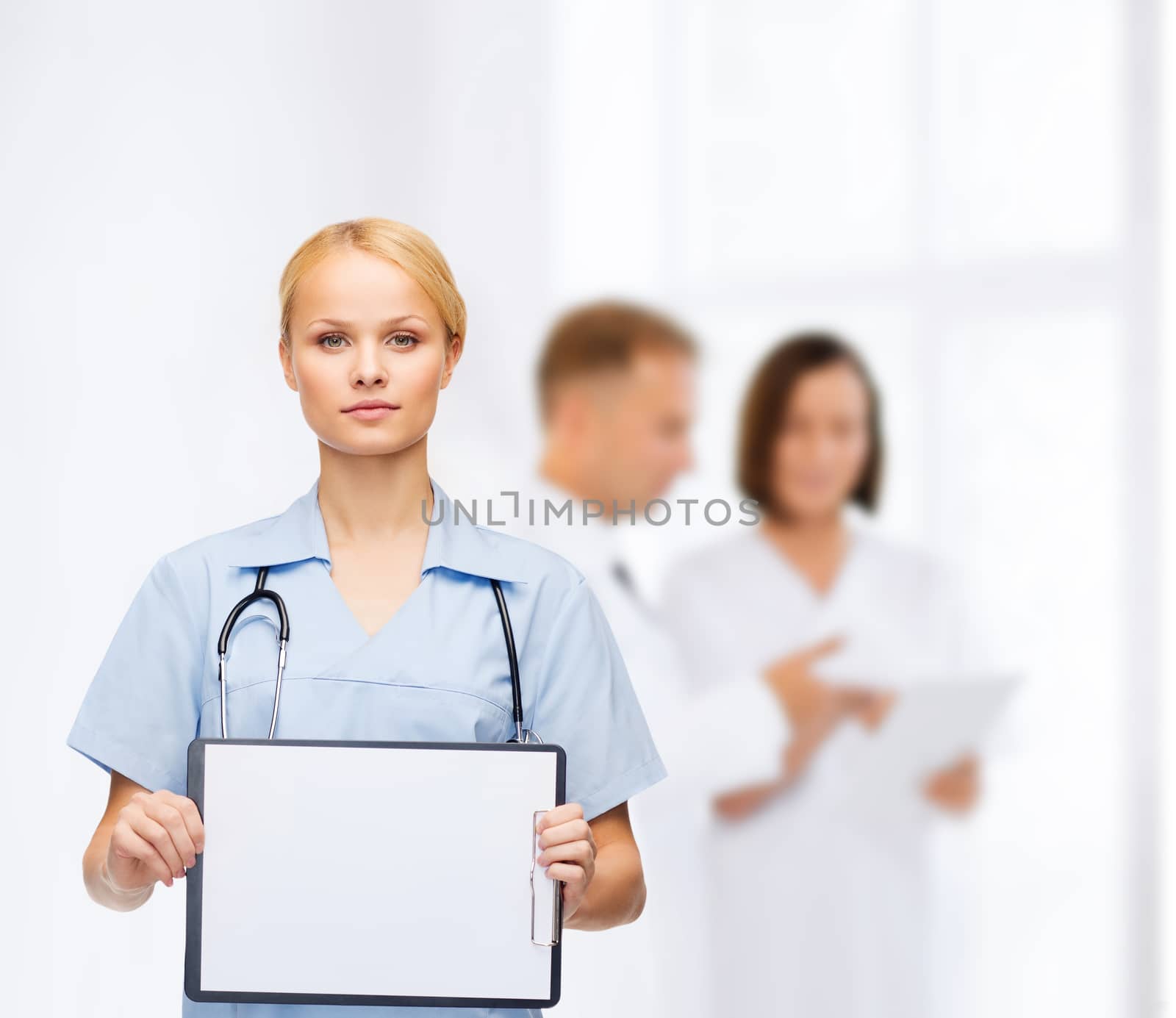 smiling female doctor or nurse with sclipboard by dolgachov