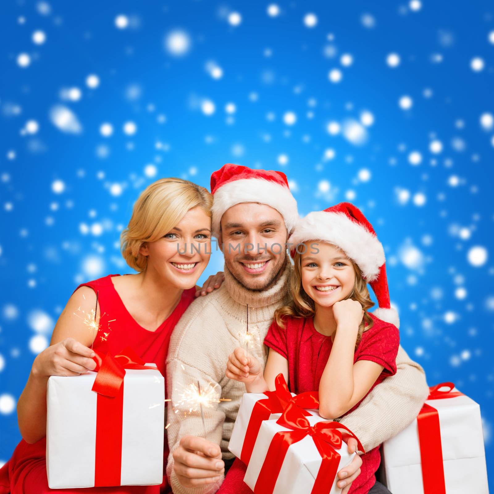 smiling family holding gift boxes and sparkles by dolgachov