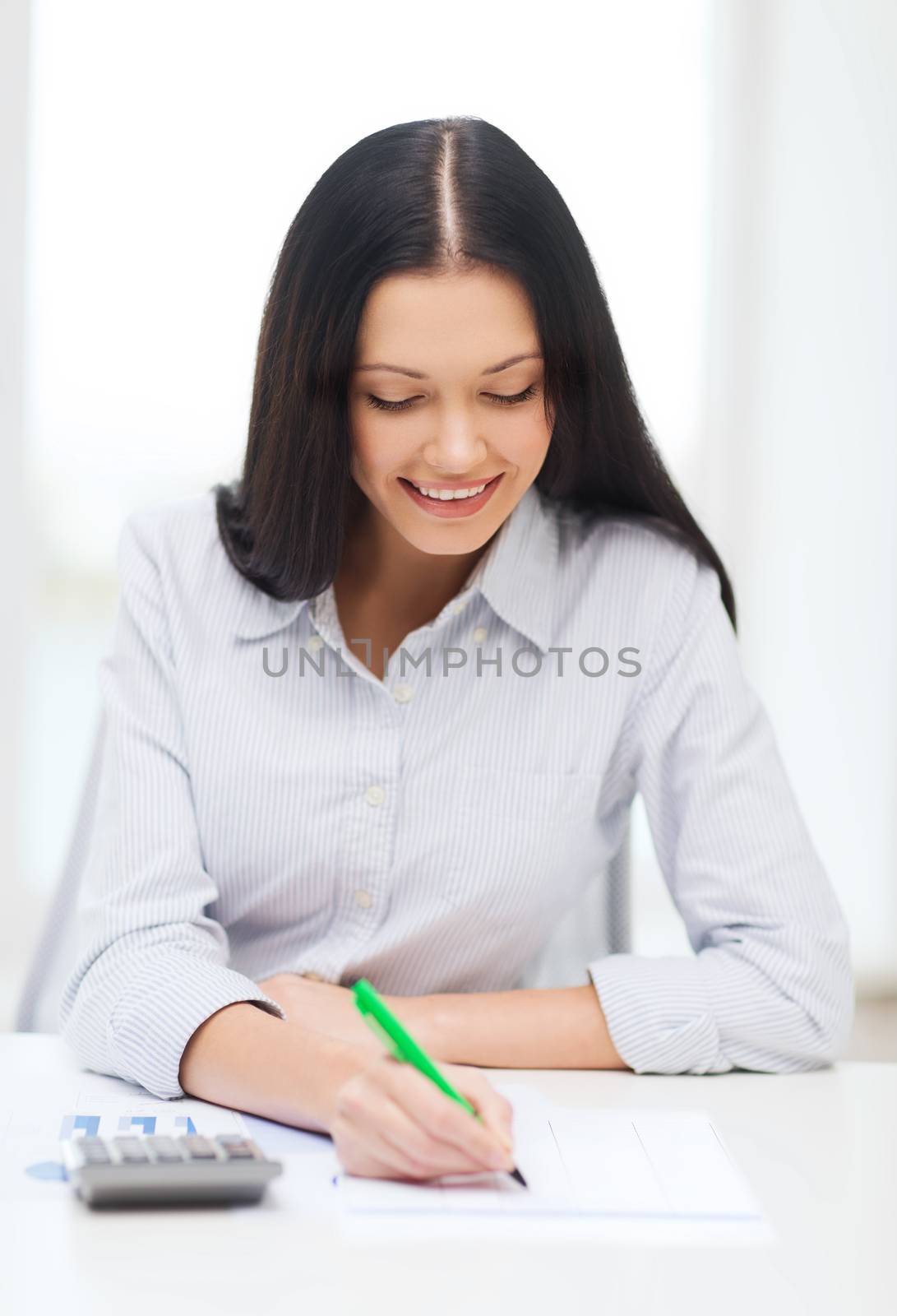 businesswoman or student working with calculator by dolgachov