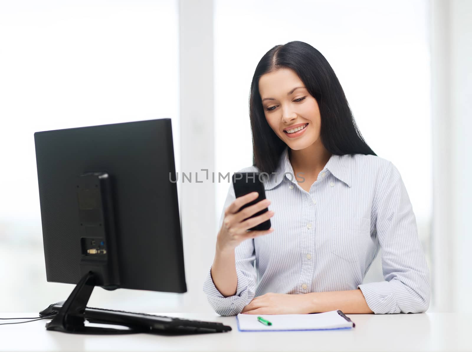 education, school, business, communication and technology concept - smiling businesswoman or student with computer and smartphone texting