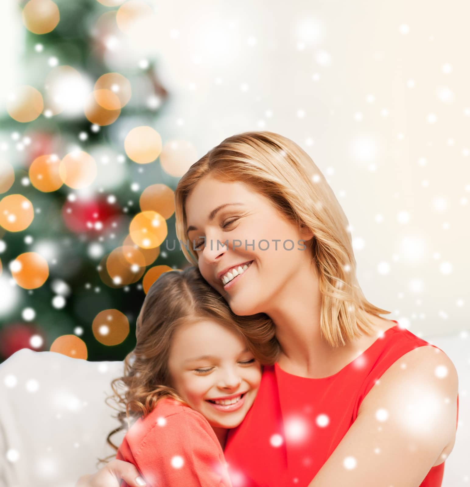 christmas, x-mas, winter, happiness concept - hugging mother and daughter