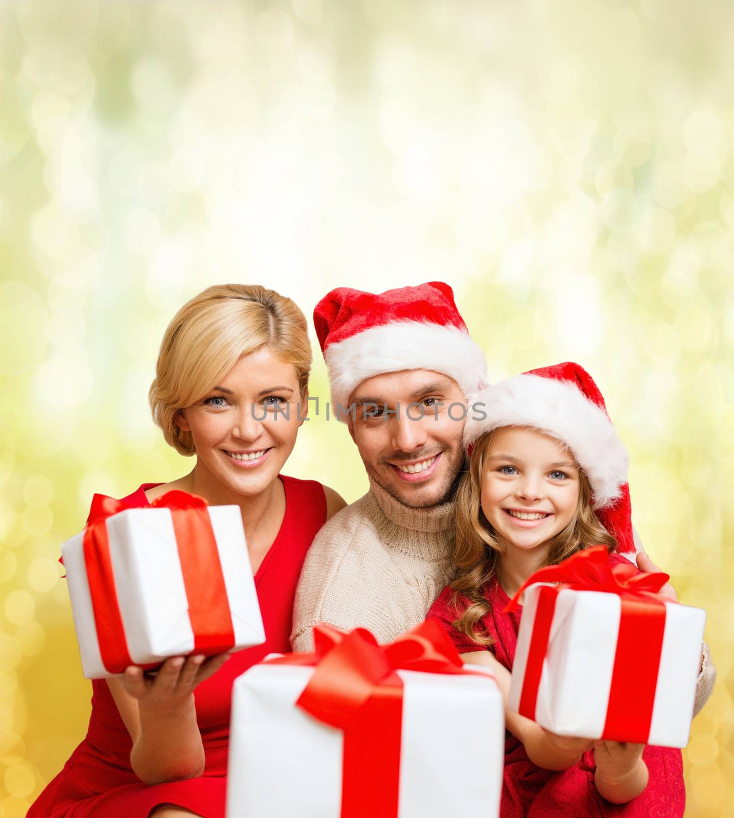 family, christmas, x-mas, winter, happiness and people concept - smiling family in santa helper hats with many gift boxes