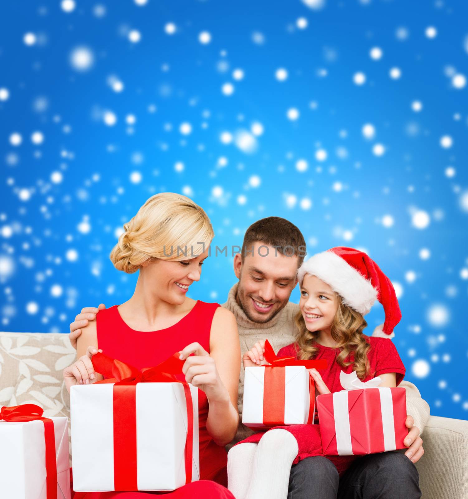 family, christmas, x-mas, winter, happiness and people concept - happy family opening gift boxes