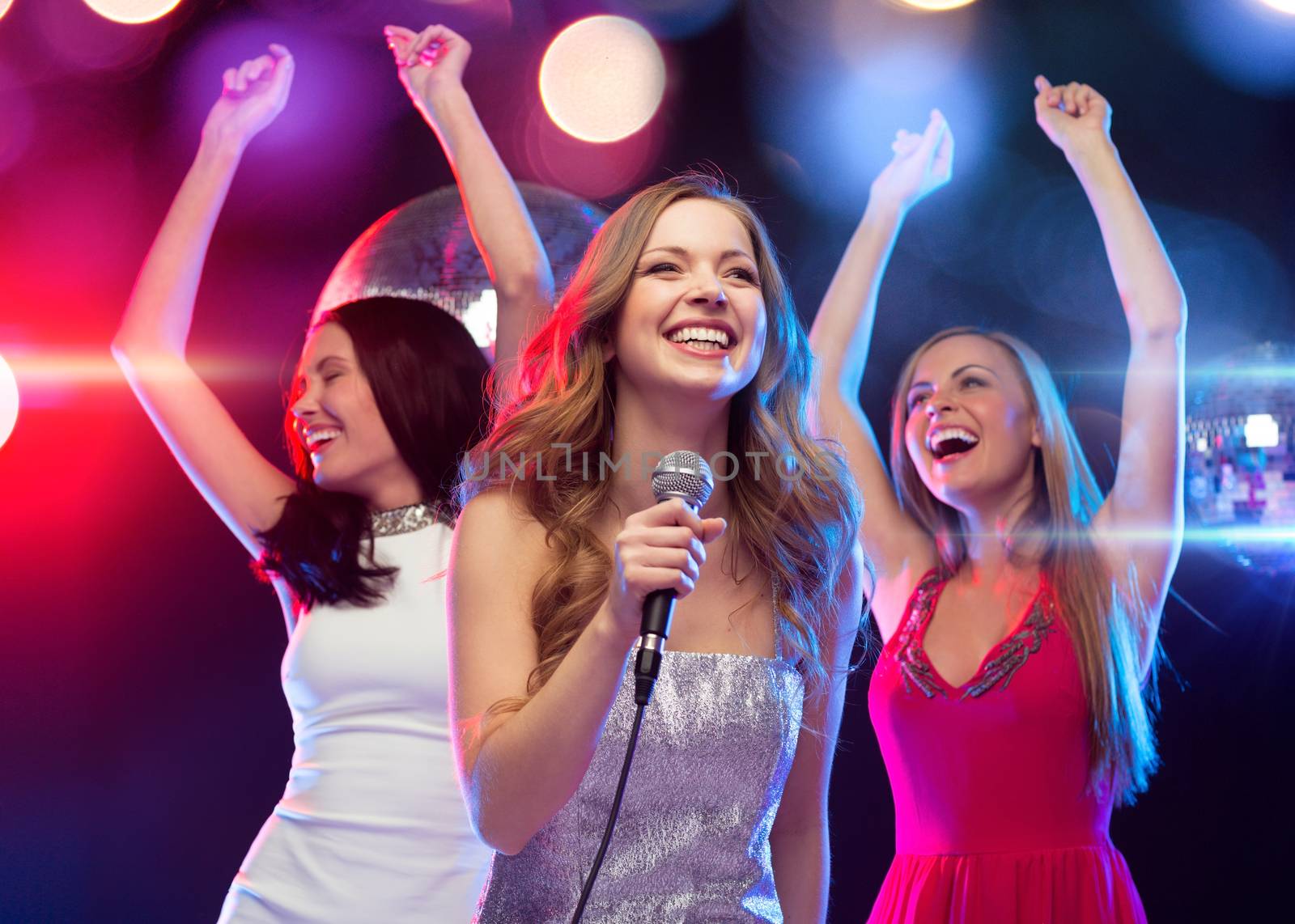 party, new year, celebration, friends, bachelorette party, birthday concept - three women in evening dresses dancing and singing karaoke