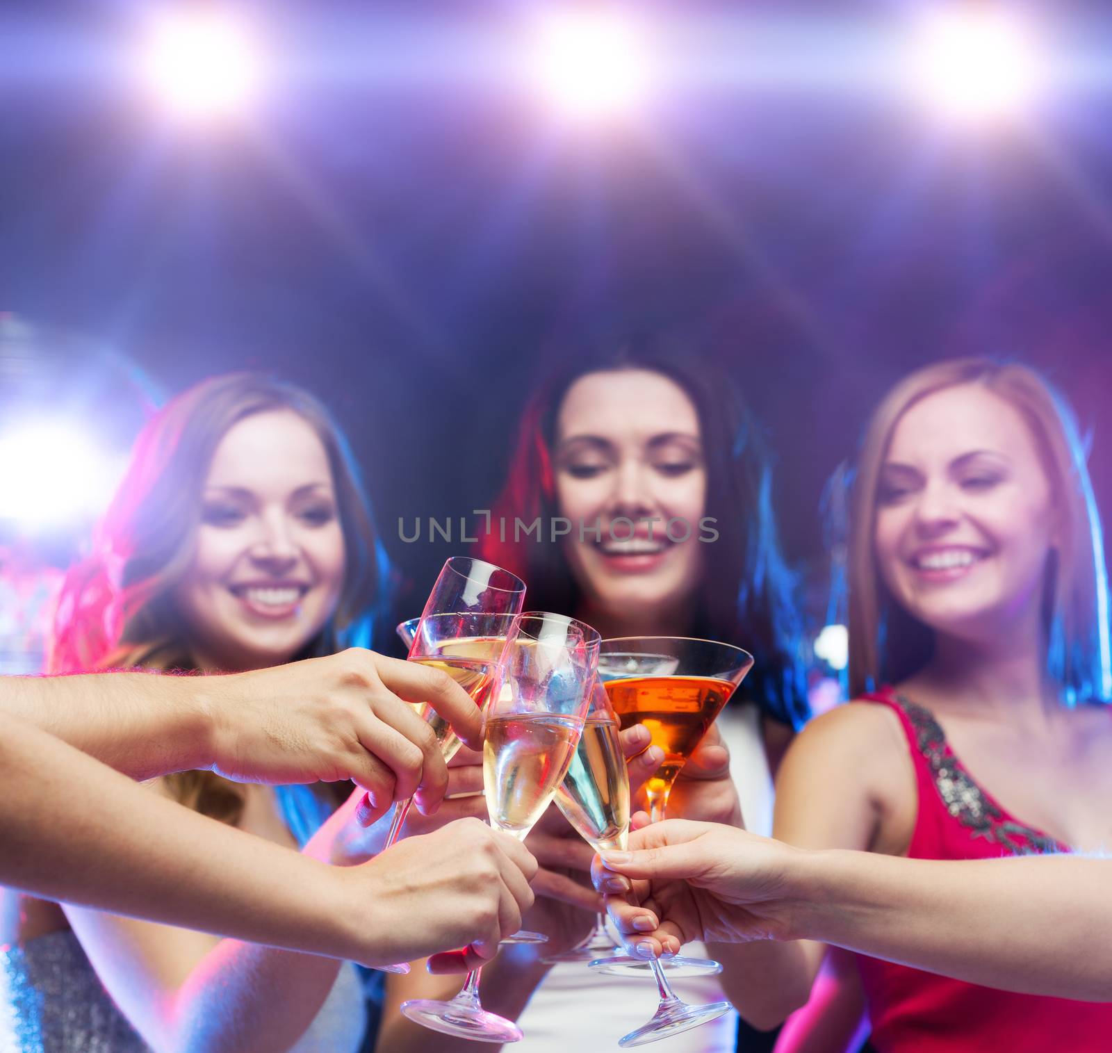 three smiling women with cocktails and disco ball by dolgachov