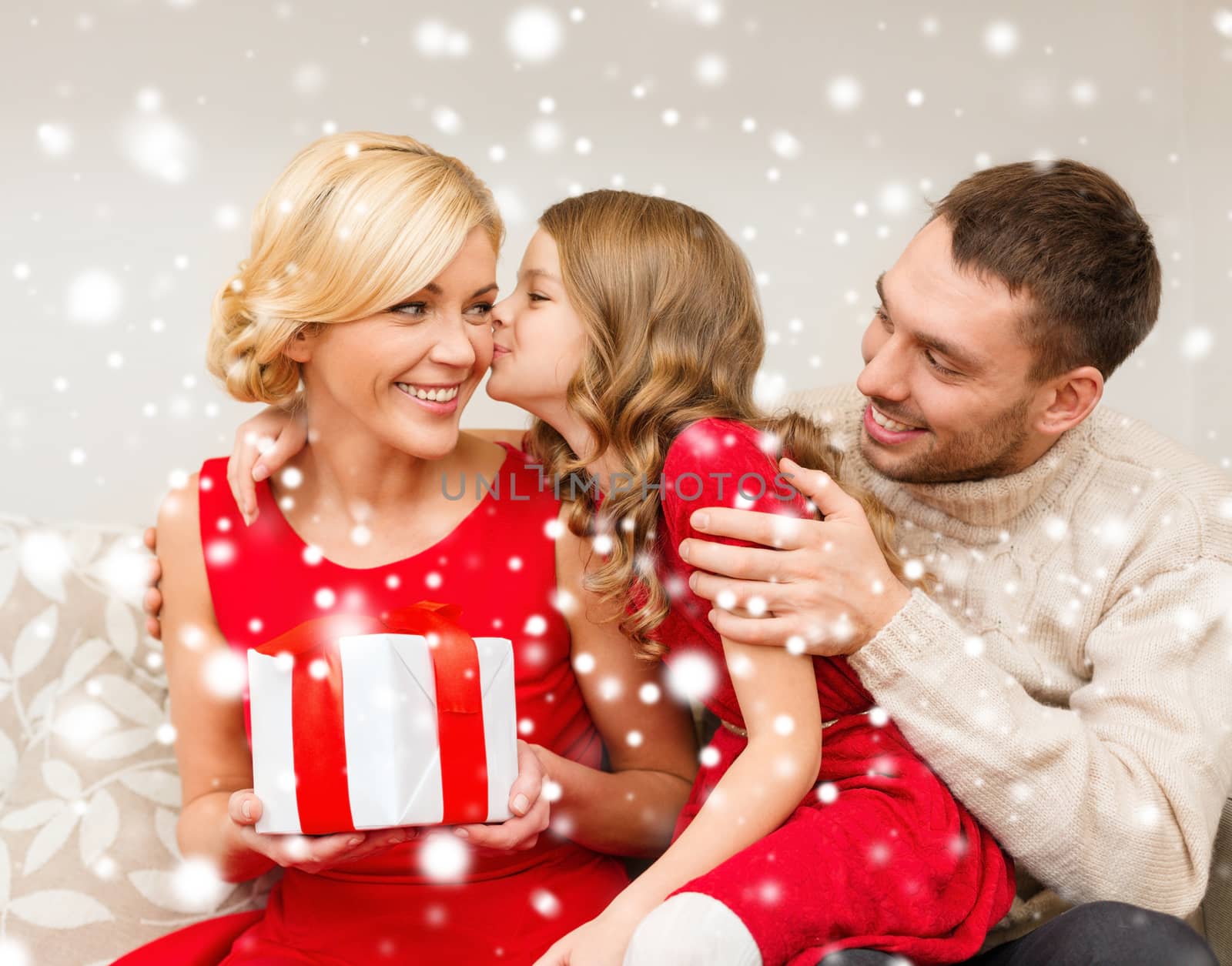 family, christmas, x-mas, winter, happiness and people concept - adorable child kisses her mother and gives present