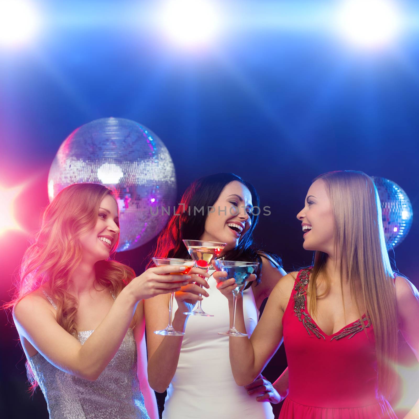 new year, celebration, friends, bachelorette party, birthday concept - three women in evening dresses with cocktails and disco ball