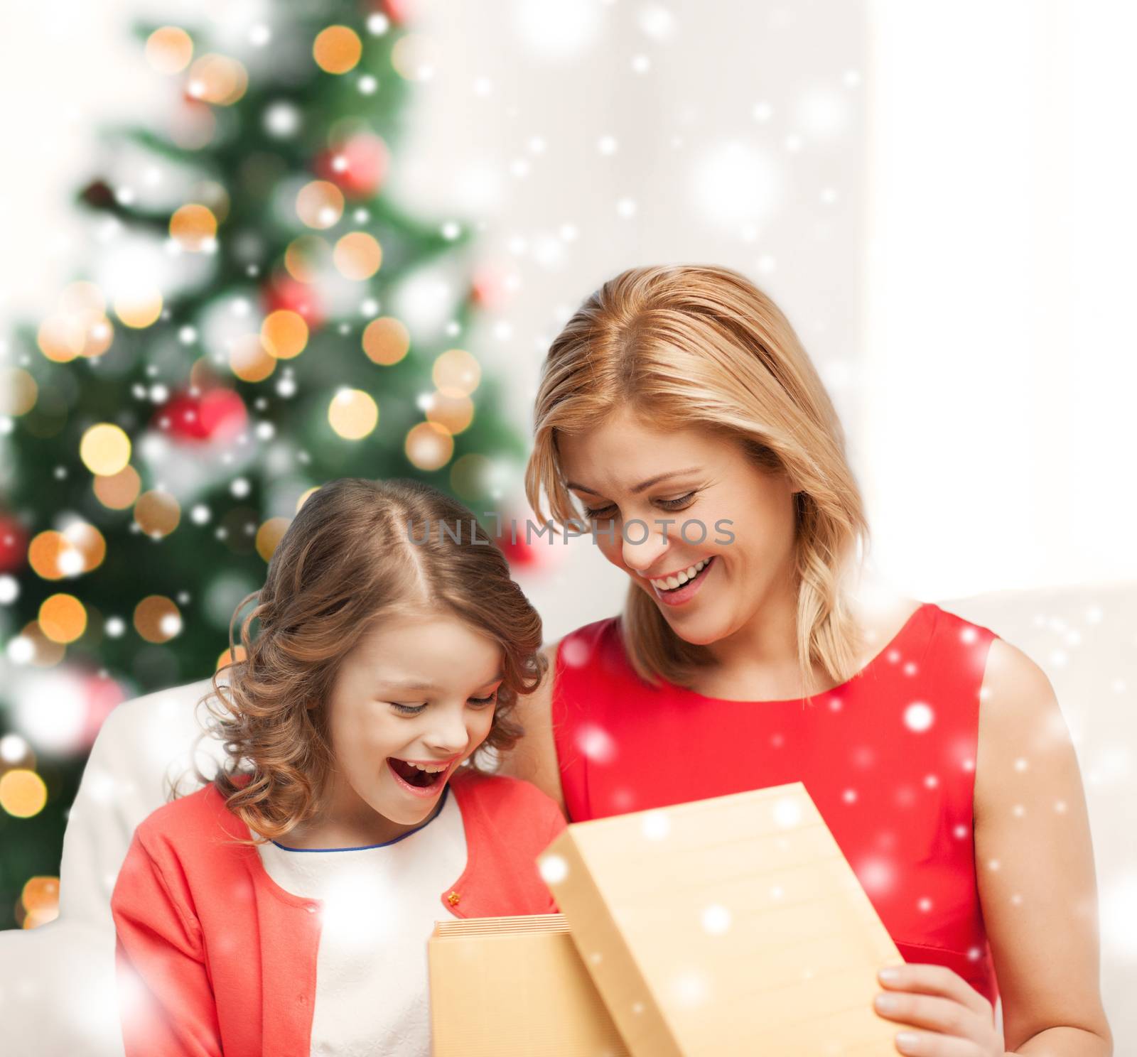 holidays, presents, christmas, x-mas, birthday concept - happy mother and child girl with gift box