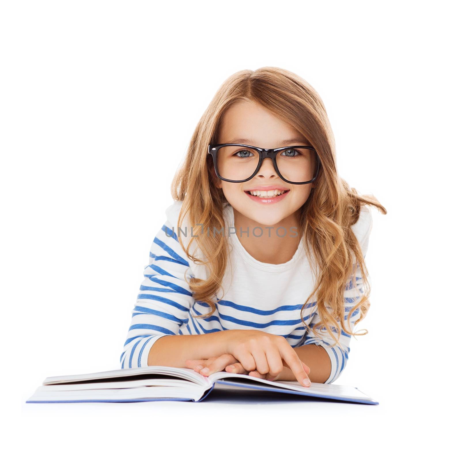 education and school concept - smiling little student girl with book and eyeglasses lying on the floor