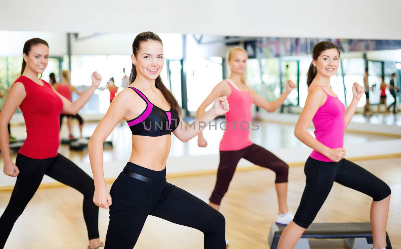 group of smiling people doing aerobics by dolgachov
