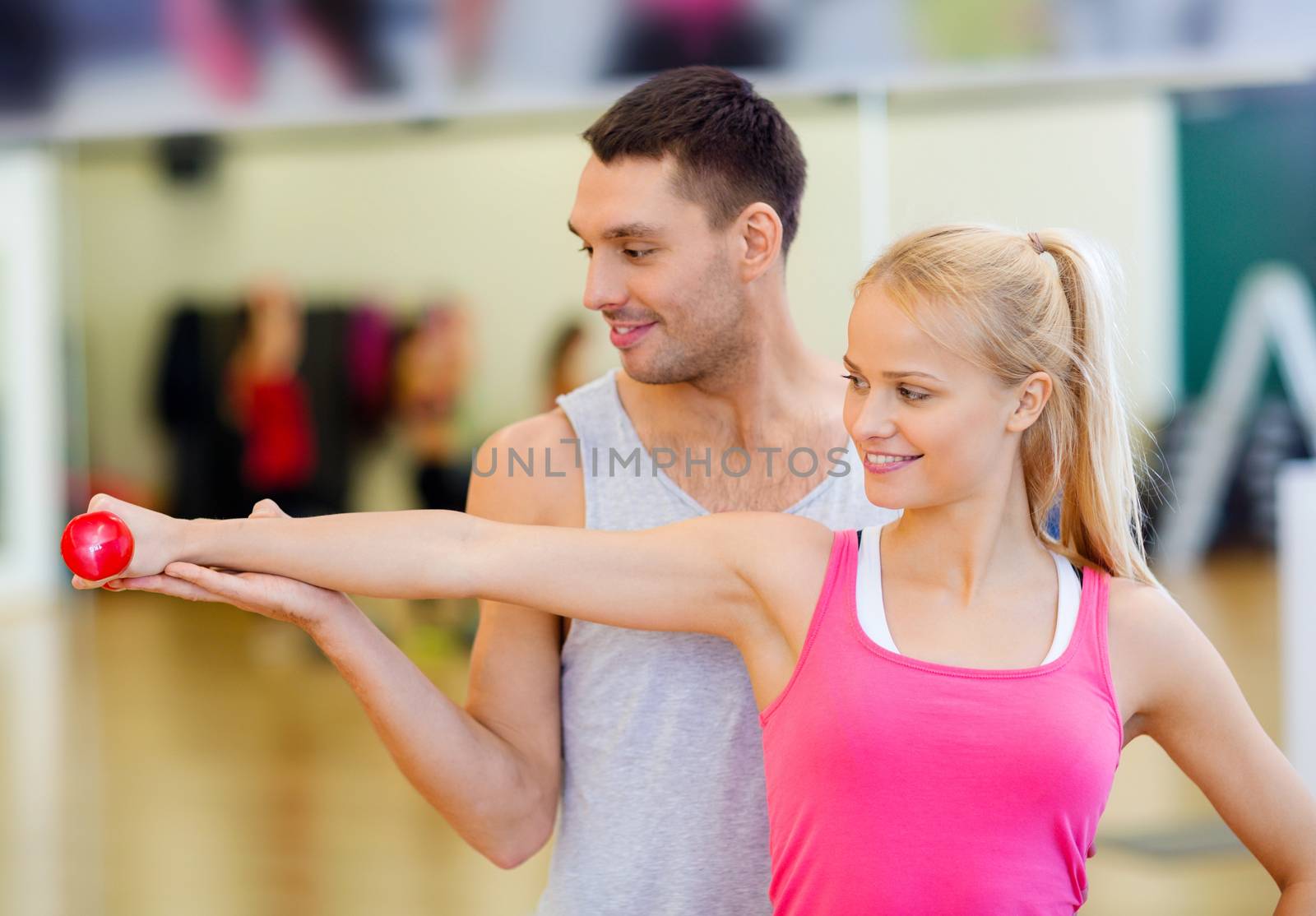 fitness, sport, training, gym and lifestyle concept - male trainer with woman working out with dumbbell