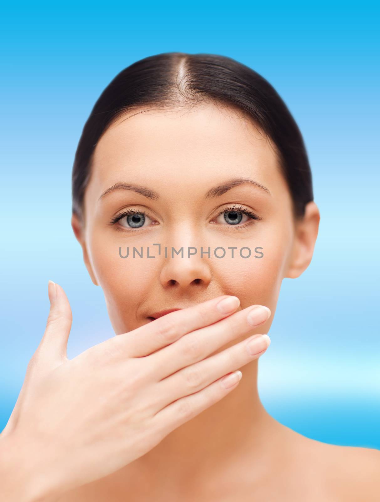 beautiful woman covering her mouth by dolgachov