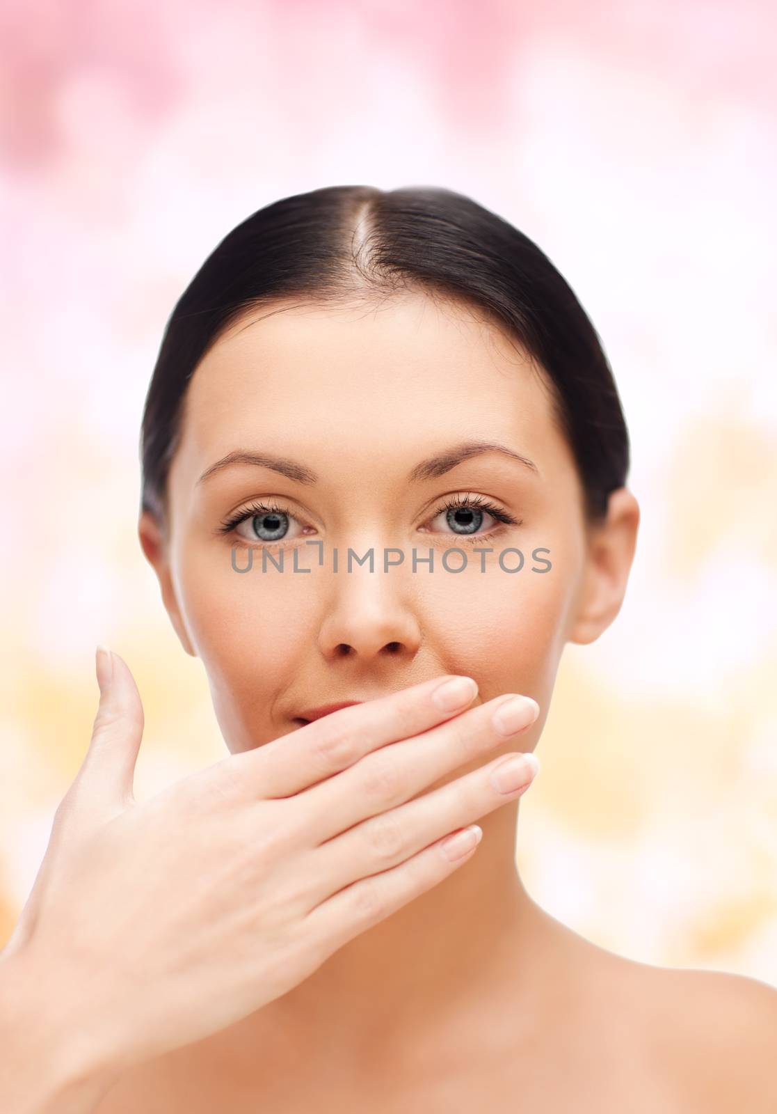 spa, health and beauty concept - beautiful woman covering her mouth