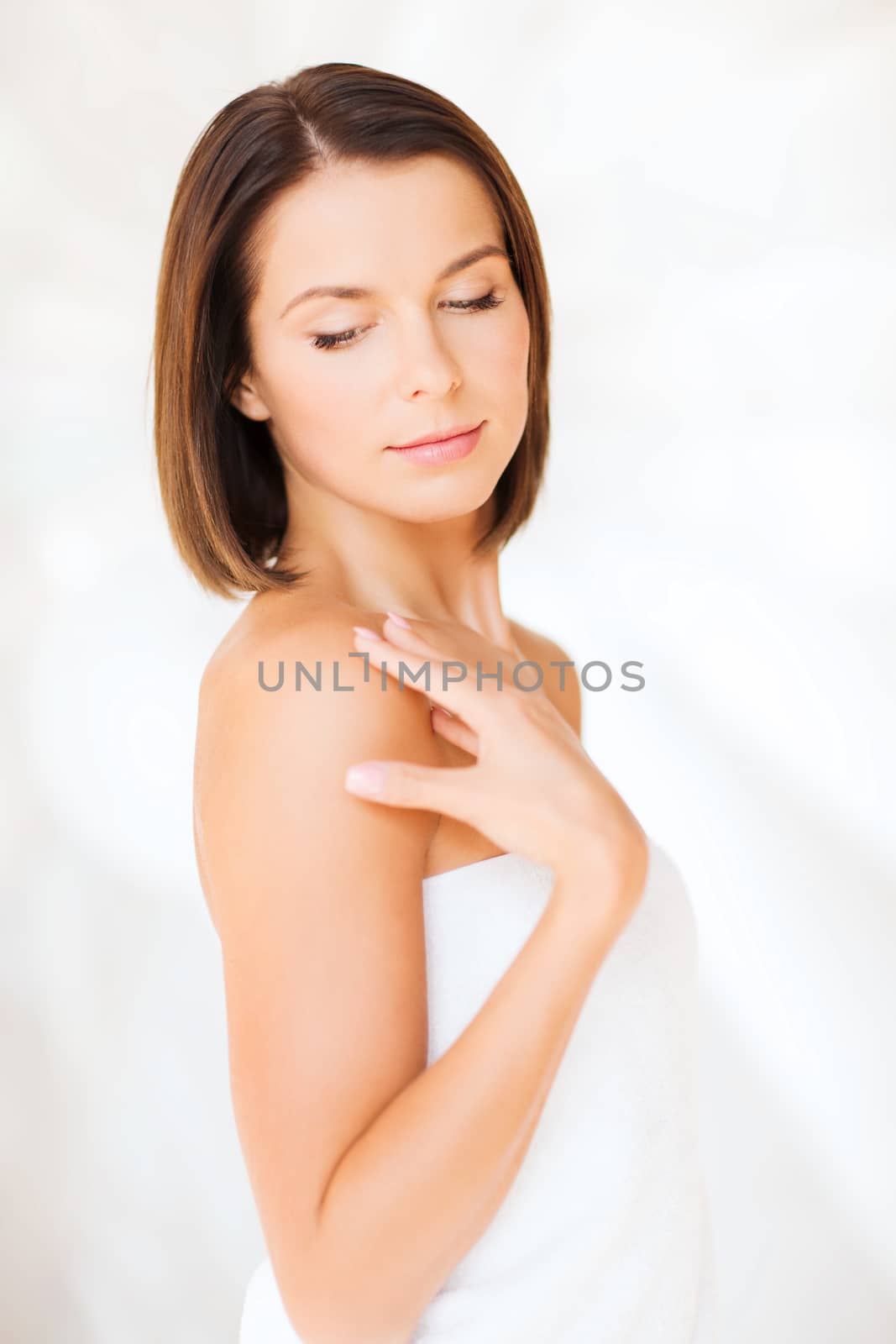 beauty, spa and people concept - beautiful woman standing in towel