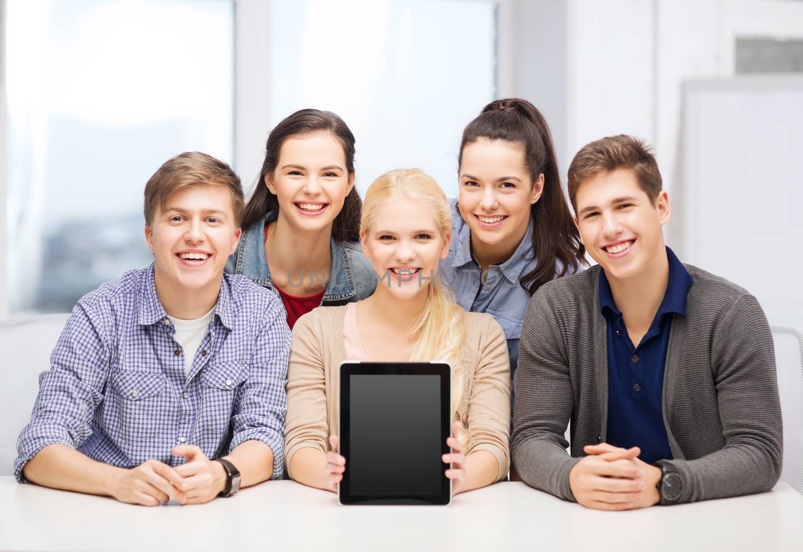 education, technology, advertisement and internet concept - group of smiling students with blank black tablet pc screen