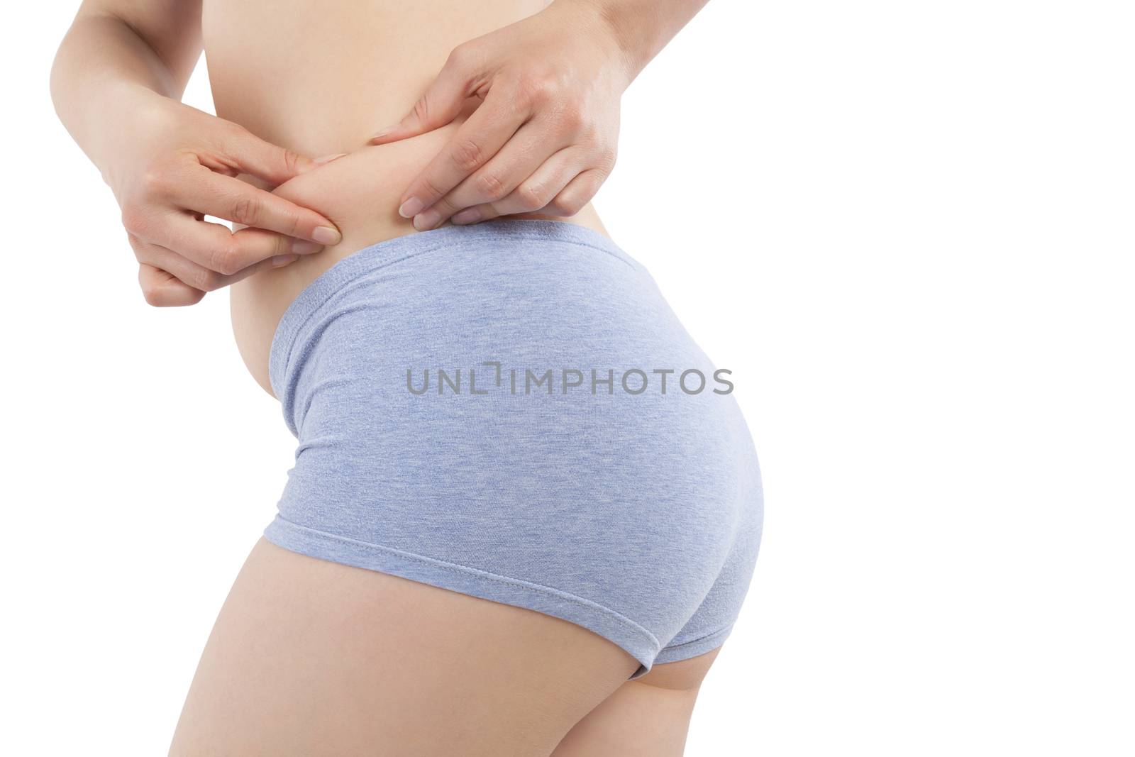 Girl in panties showing body fat on hips isolated on white background. Weight loss and plastic surgery concept.