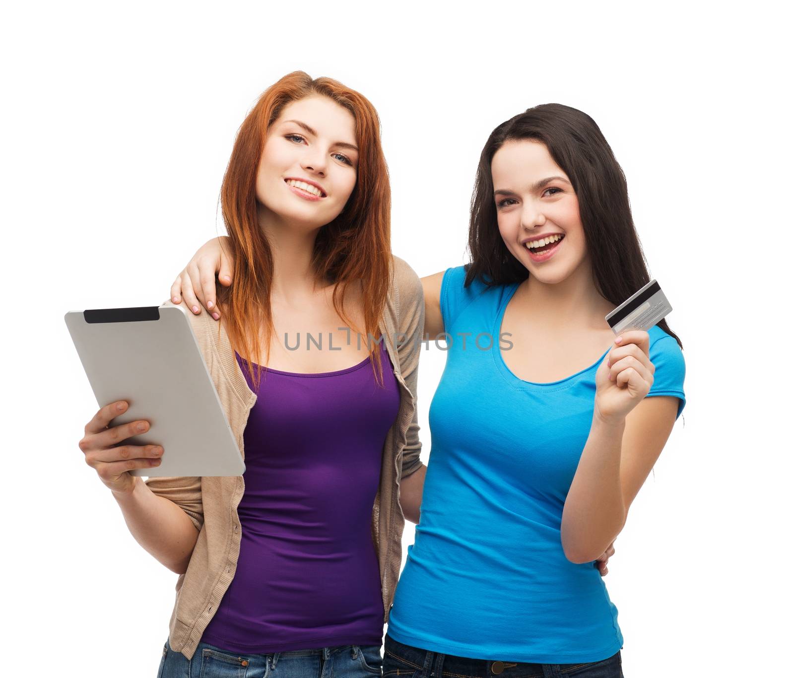 online shopping and technology concept - two smiling teenagers with tablet pc computer and credit card