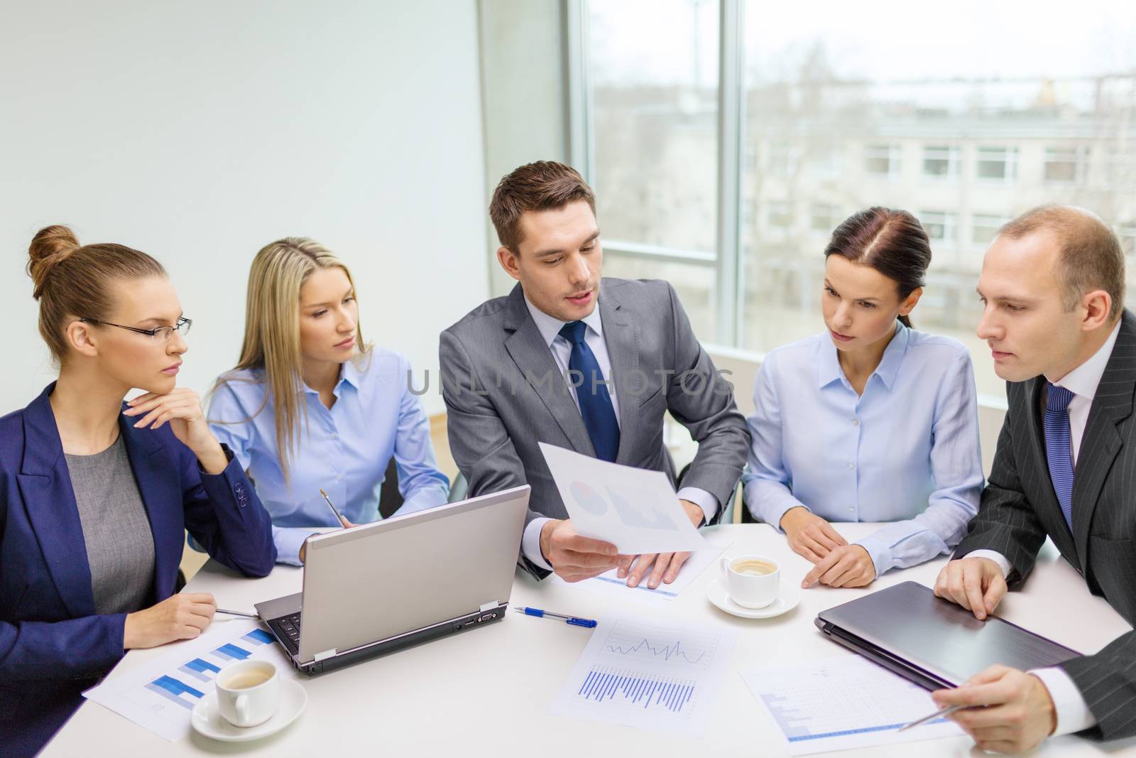 business team with laptop having discussion by dolgachov