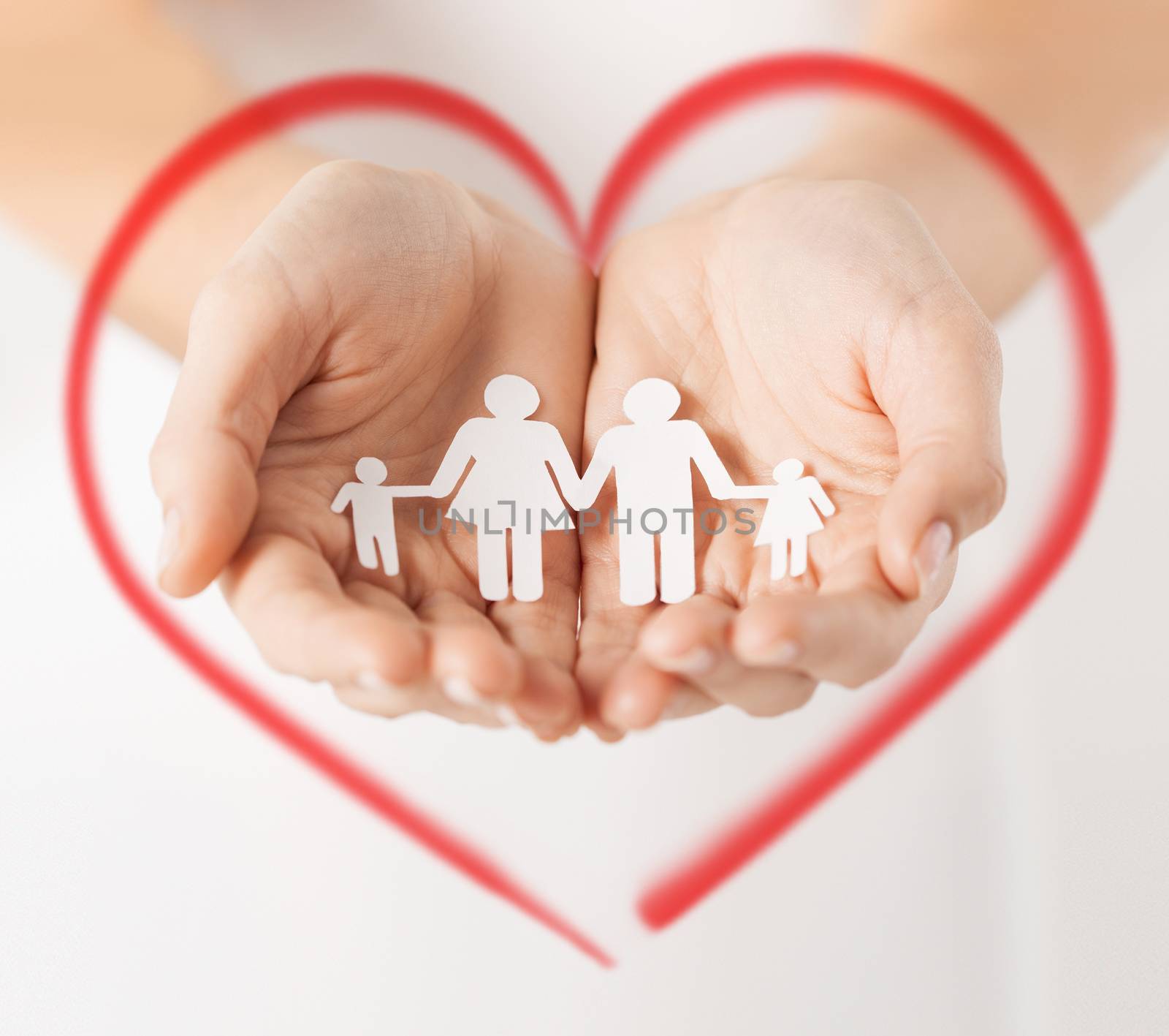 love, family and happiness concept - close up of womans hands showing paper man family