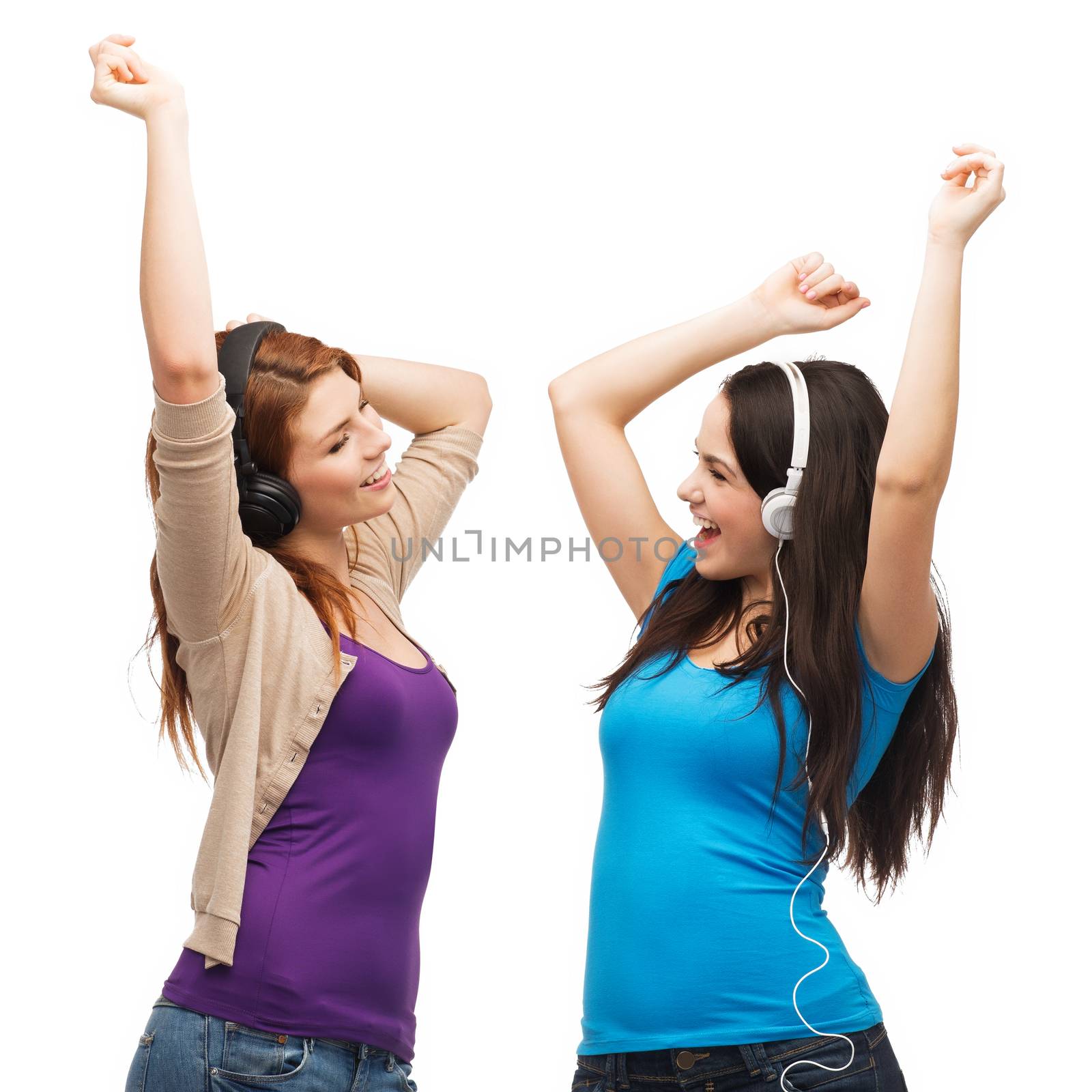 two laughing girls with headphones dancing by dolgachov