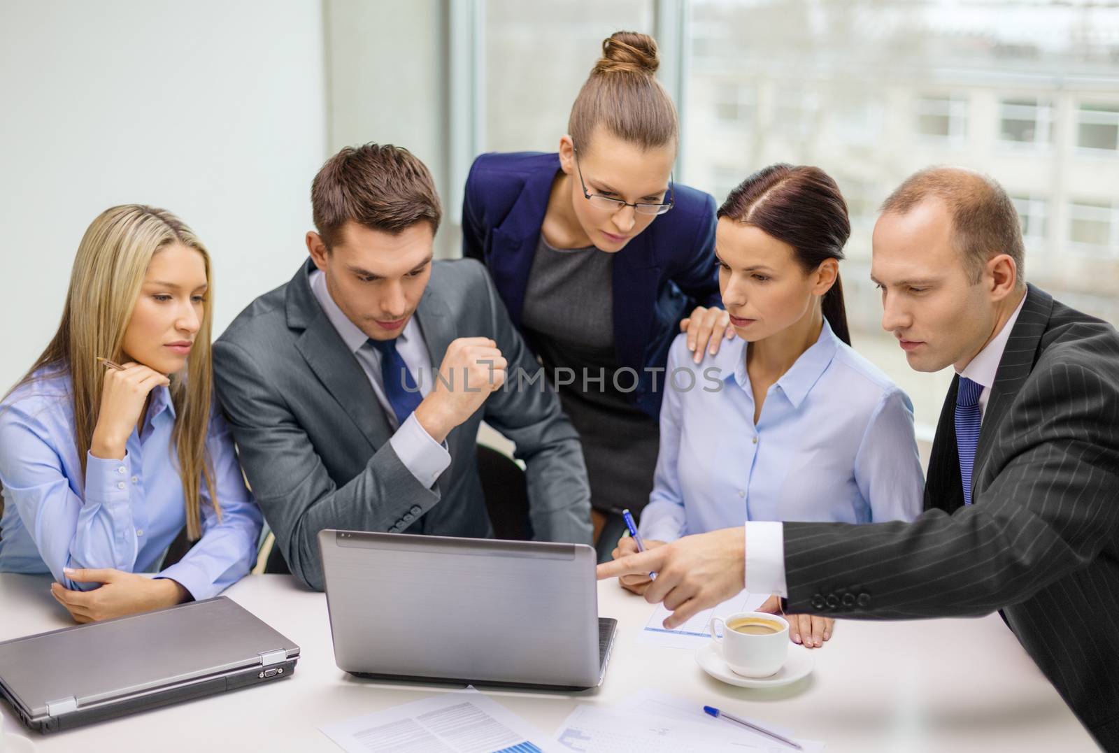 business team with laptop having discussion by dolgachov