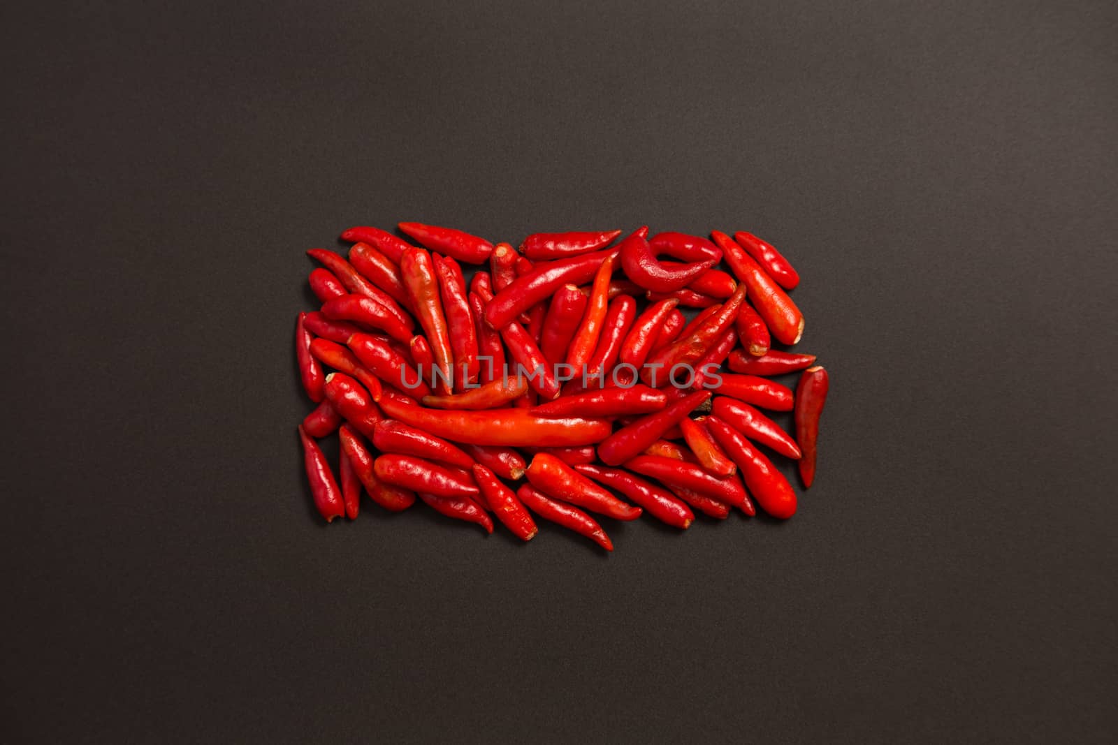 Non-stem red bird eye chili pepper on grey background 