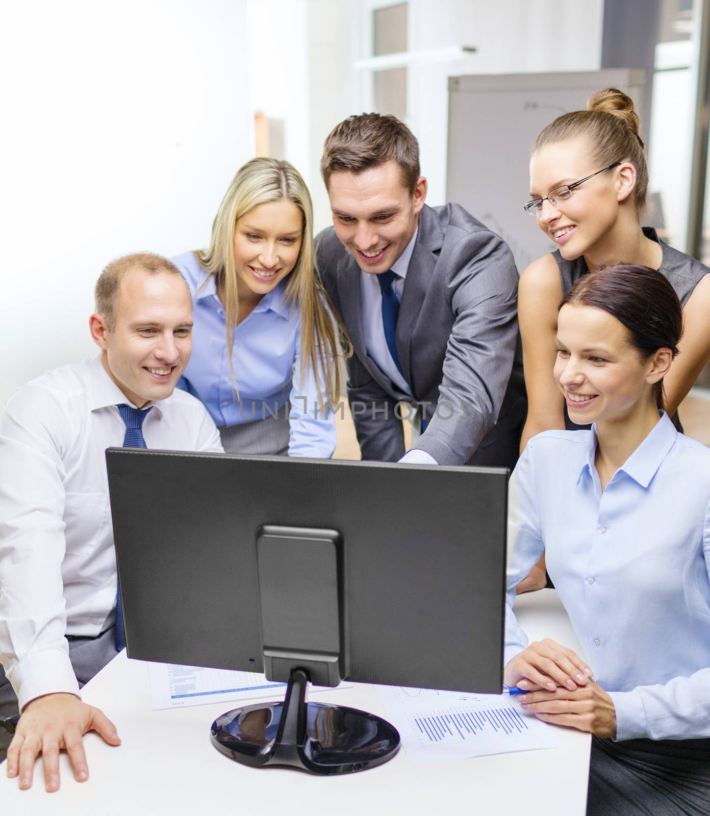 business team with monitor having discussion by dolgachov