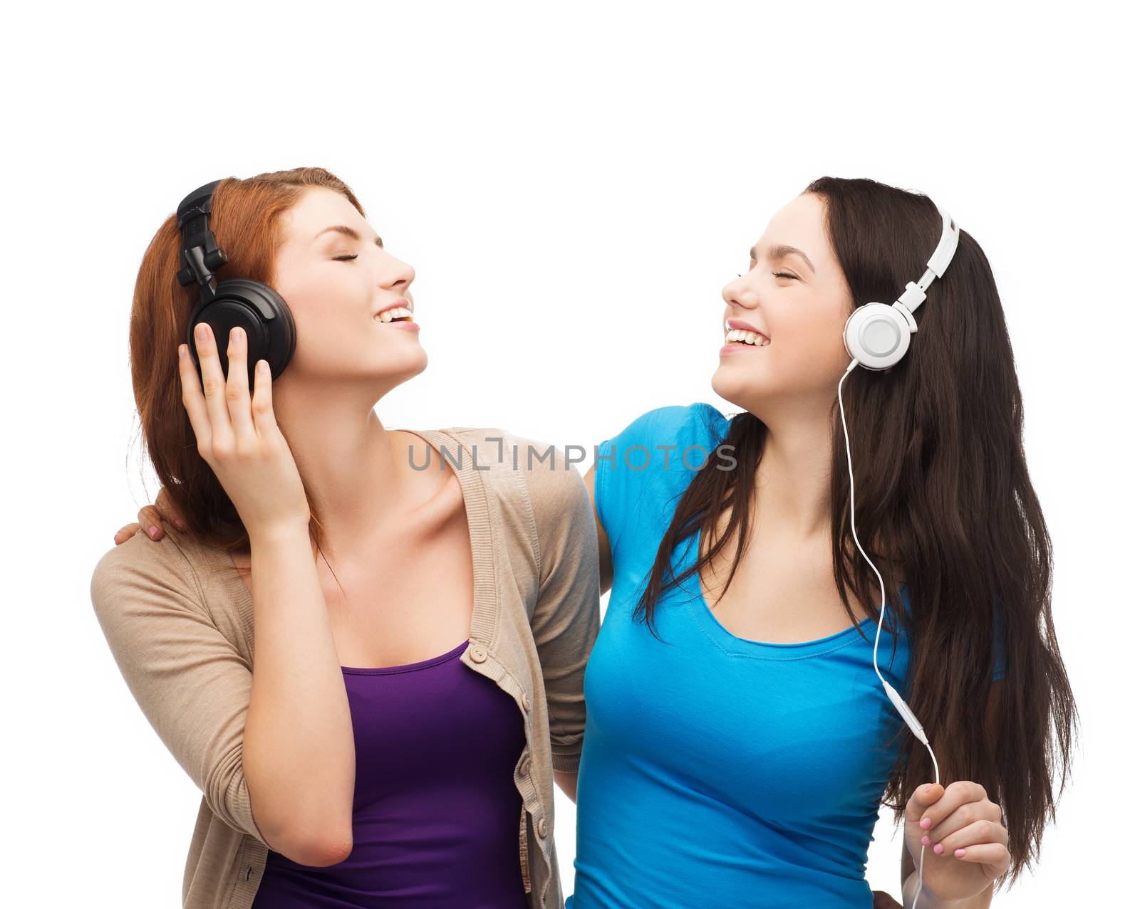 two smiling teenagers with headphones by dolgachov