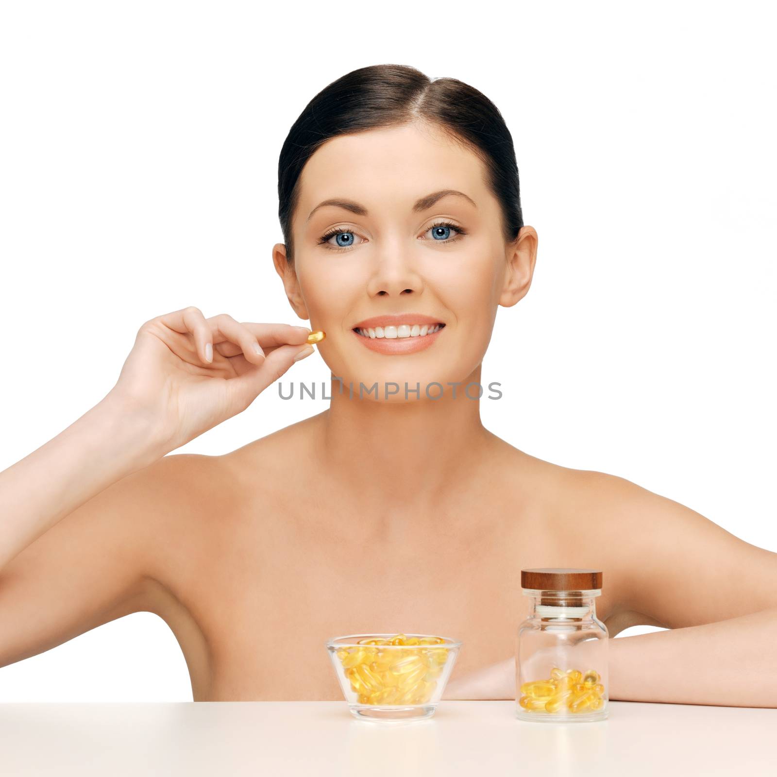 healthcare and beauty concept - beautiful woman with omega 3 vitamins
