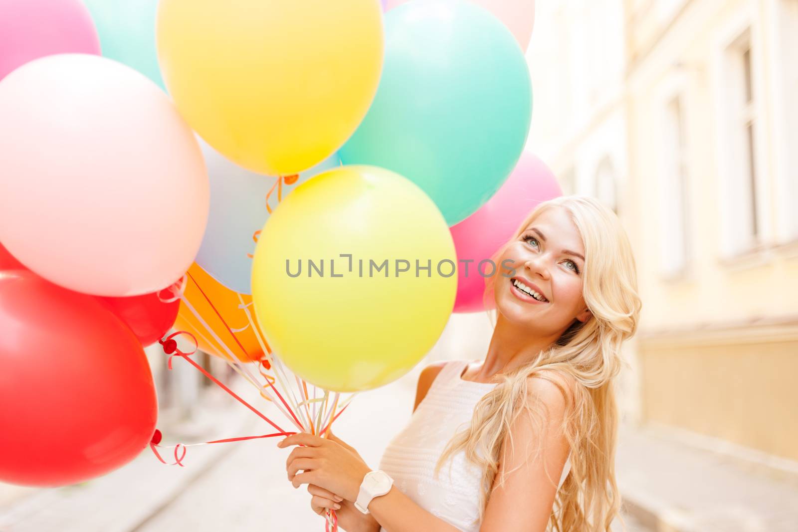 summer holidays, celebration and lifestyle concept - beautiful woman with colorful balloons in the city