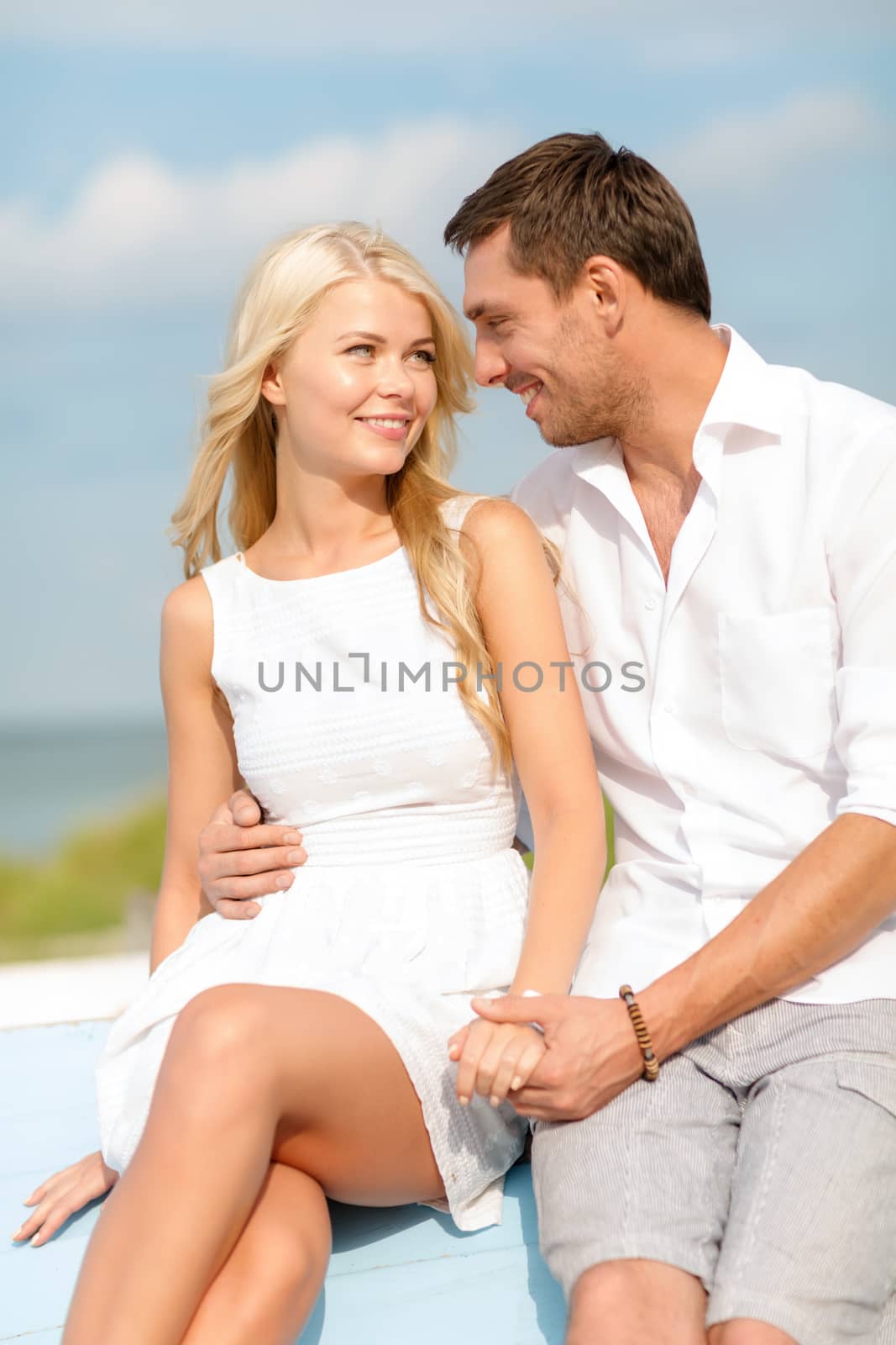 smiling couple at sea side by dolgachov